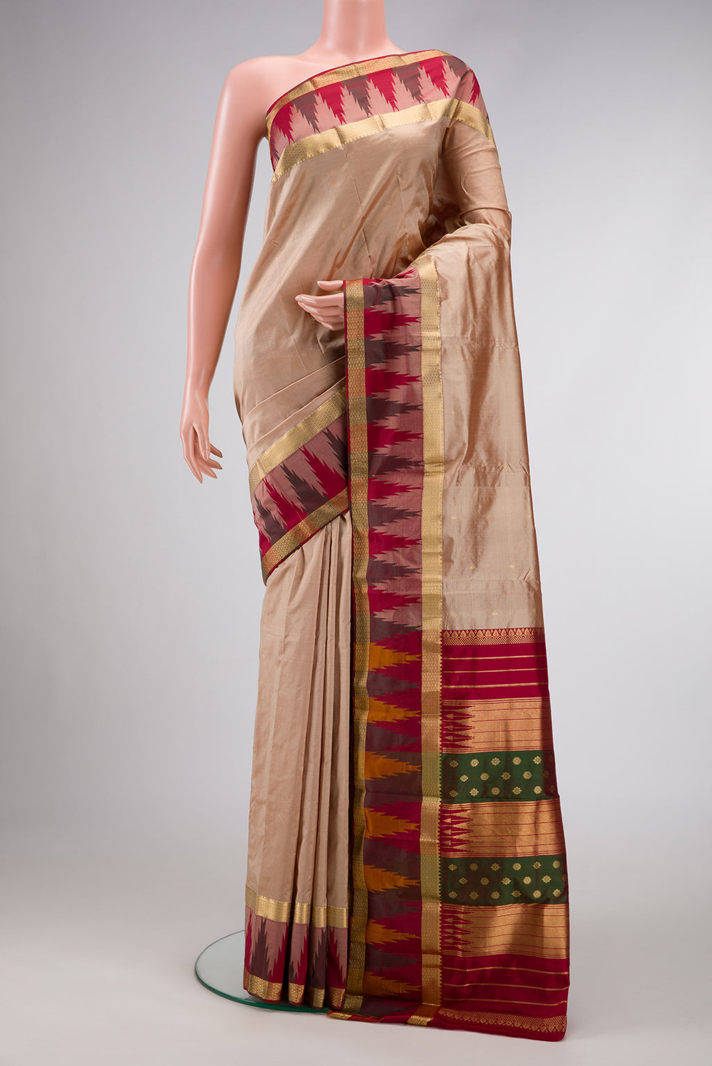 Beige Dual Tone Kanchipuram Silk Saree with Zari Butta on the body and Temple Border.  displayed on a mannequin