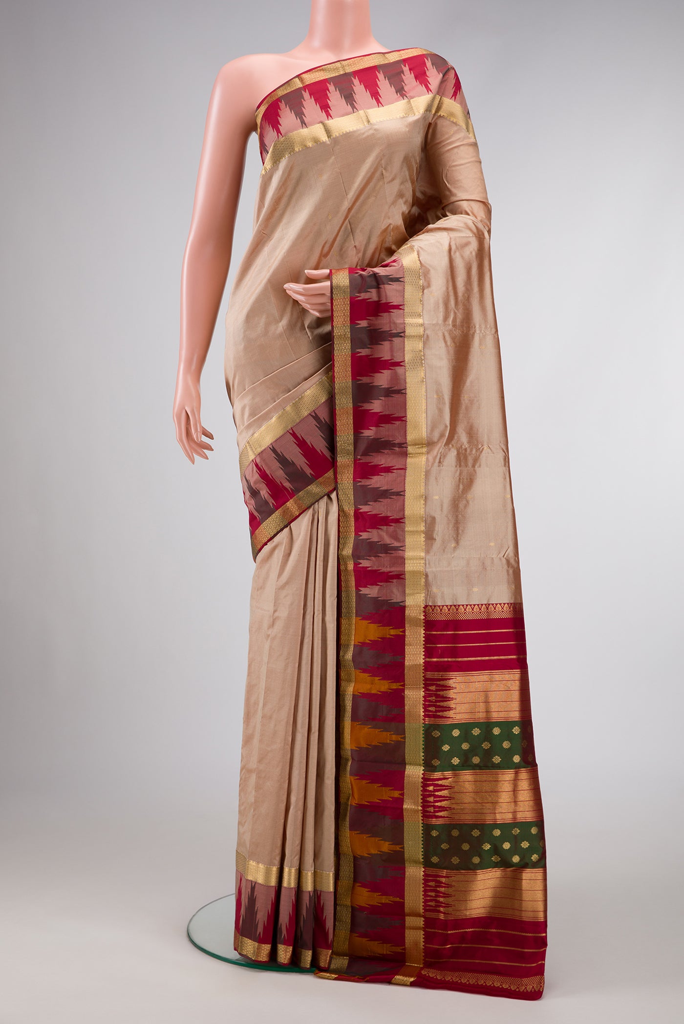 Beige Dual Tone Kanchipuram Silk Saree with Zari Butta on the body and Temple Border.  displayed on a mannequin