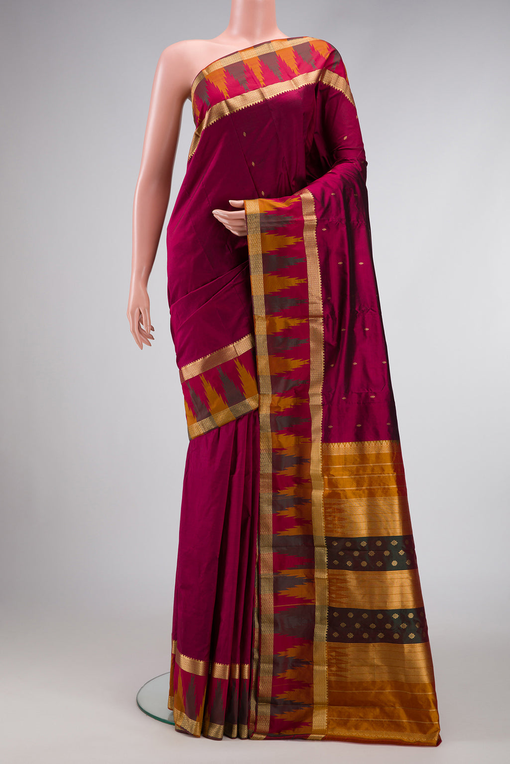 Burgundy Dual Tone Kanchipuram Silk Saree with Zari Butta on the body and Temple Border.  displayed on a mannequin