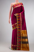 Burgundy Dual Tone Kanchipuram Silk Saree with Zari Butta on the body and Temple Border.  displayed on a mannequin