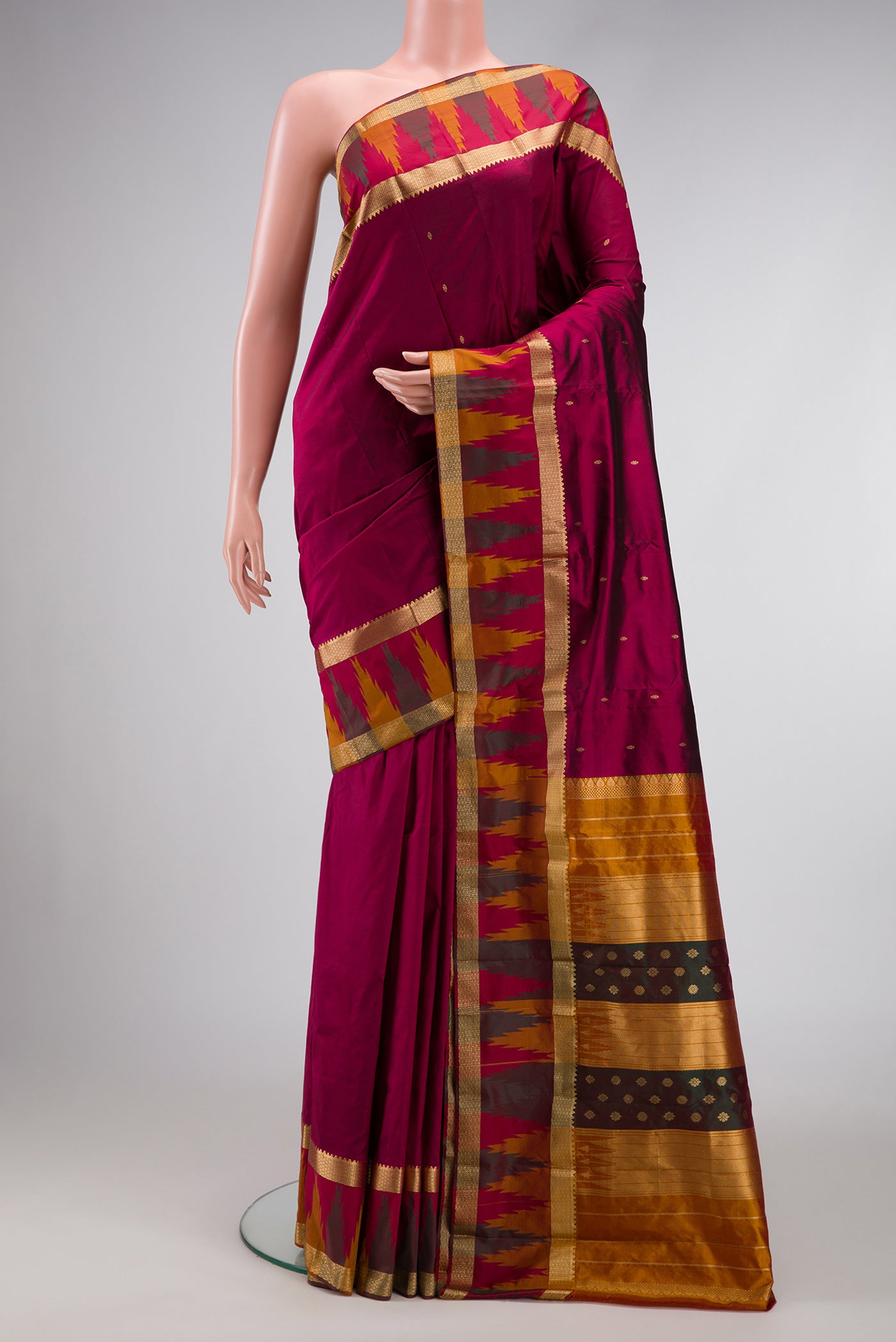 Burgundy Dual Tone Kanchipuram Silk Saree with Zari Butta on the body and Temple Border.  displayed on a mannequin