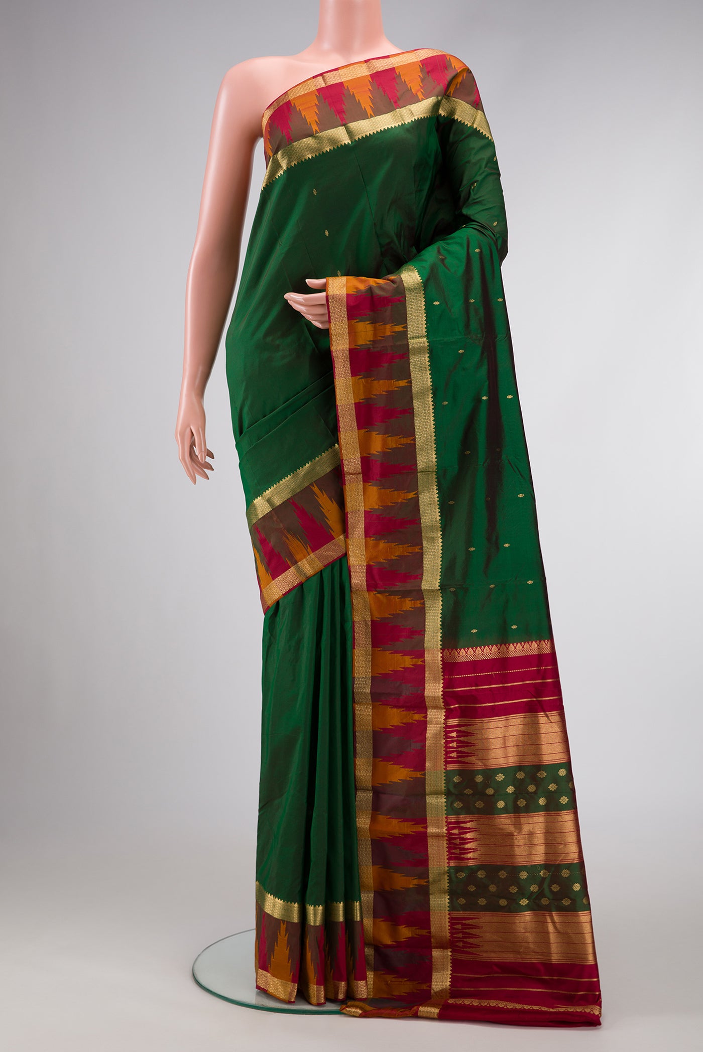 Green Dual Tone Kanchipuram Silk Saree with Zari Butta on the body and Temple Border.  displayed on a mannequin