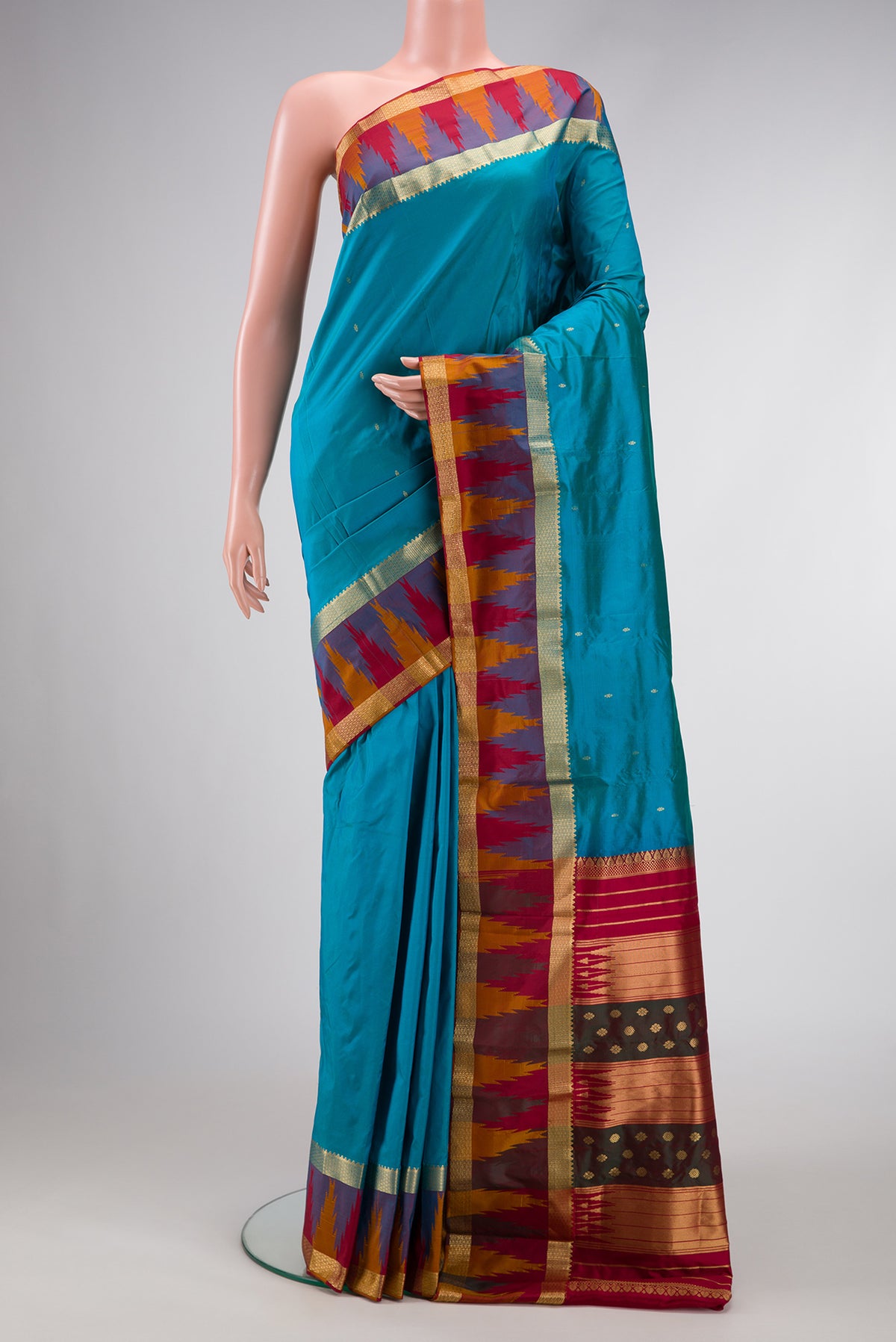 Sky Blue Dual Tone Kanchipuram Silk Saree with Zari Butta on the body and Temple Border.  displayed on a mannequin