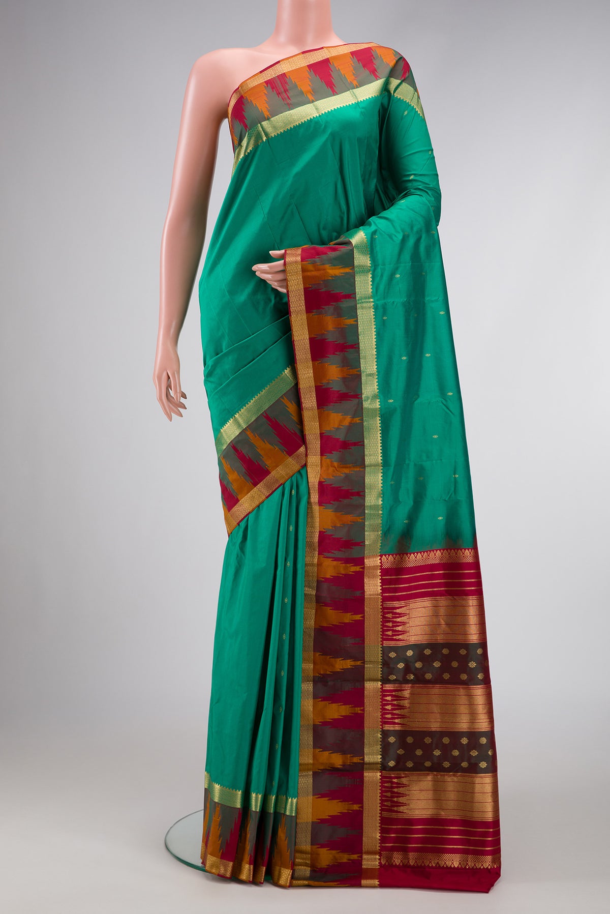 Green Dual Tone Kanchipuram Silk Saree with Zari Butta on the body and Temple Border.  displayed on a mannequin