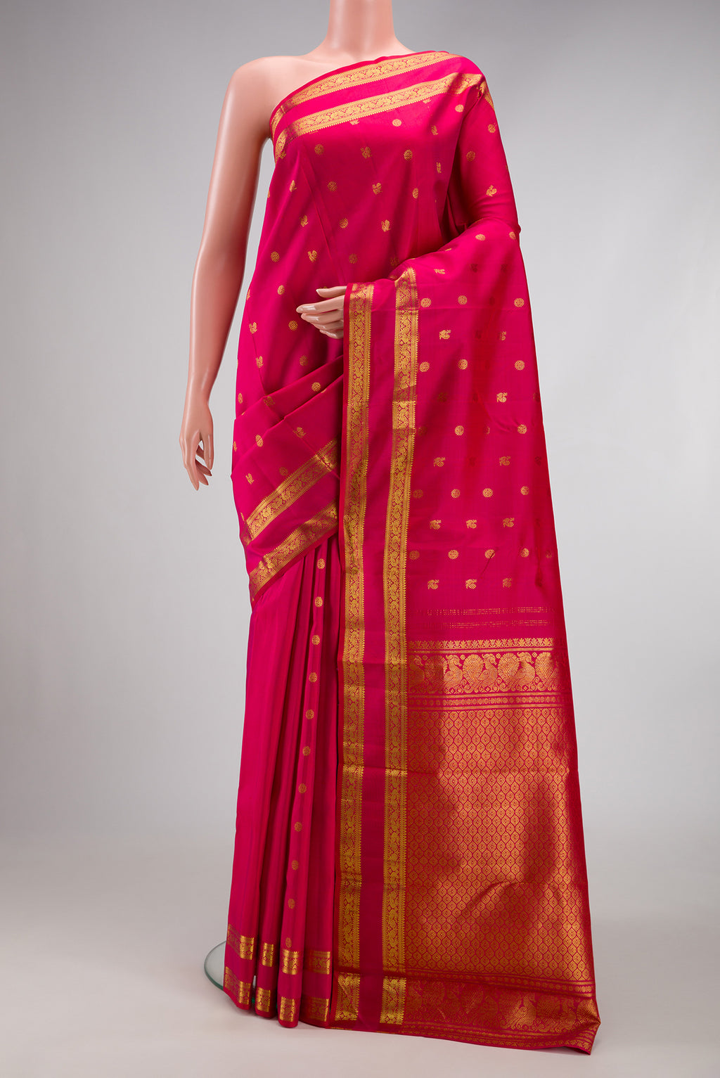 Dark Pink Kanjivaram Silk Saree with Zari Butta on the body and Zari Border.  displayed on a mannequin