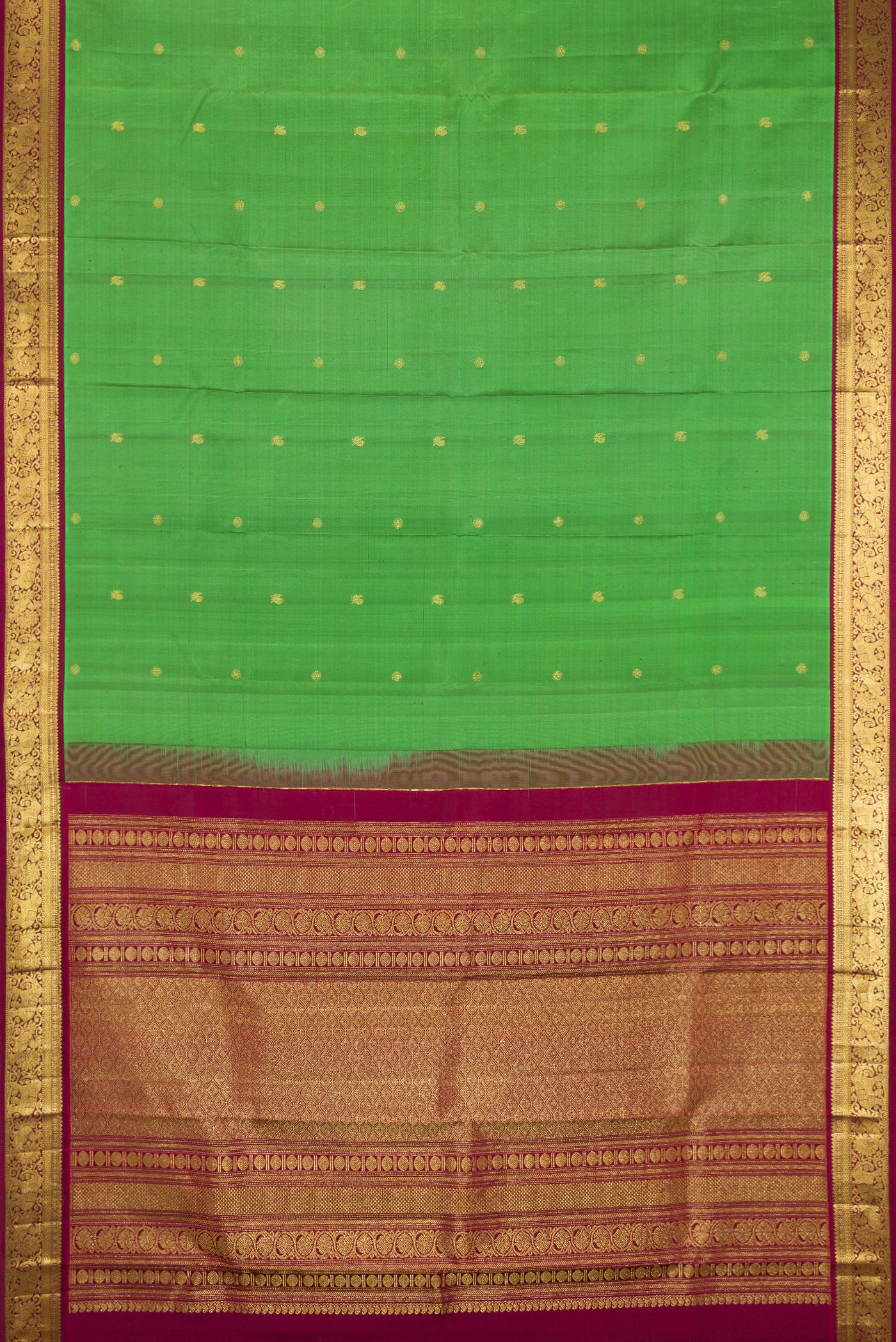 Flat view of Green Kanchipuram Silk Saree with Zari Butta on the body and Zari Border. 