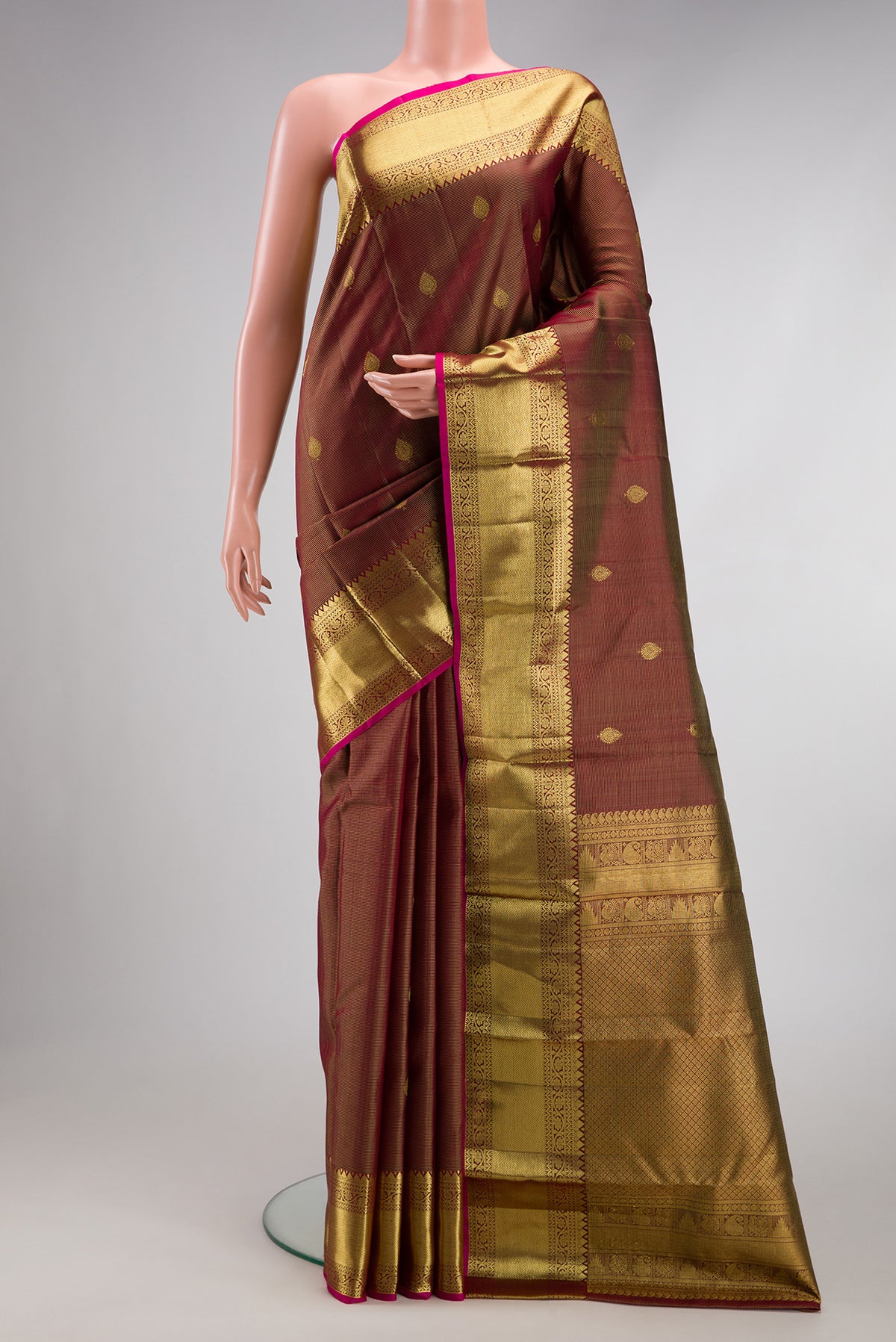 Brown Dual Tone Kanchipuram Silk Saree with Stripes on the body and Zari Border.  displayed on a mannequin