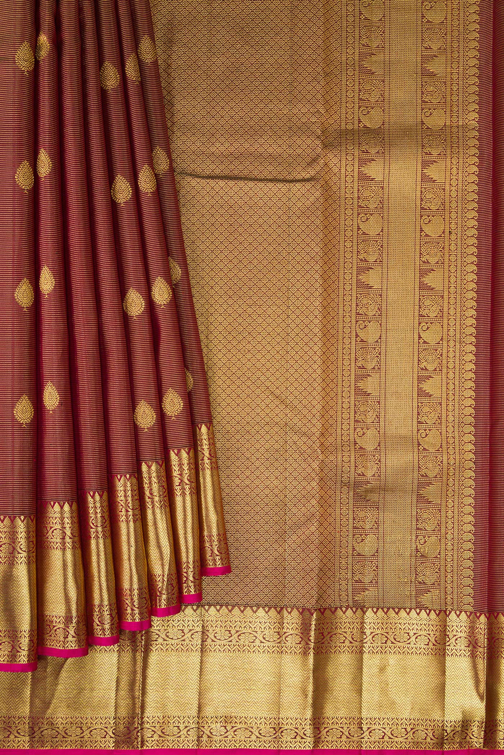 Pleats and pallu of Brown Dual Tone Kanchipuram Silk Saree with Stripes on the body and Zari Border. 