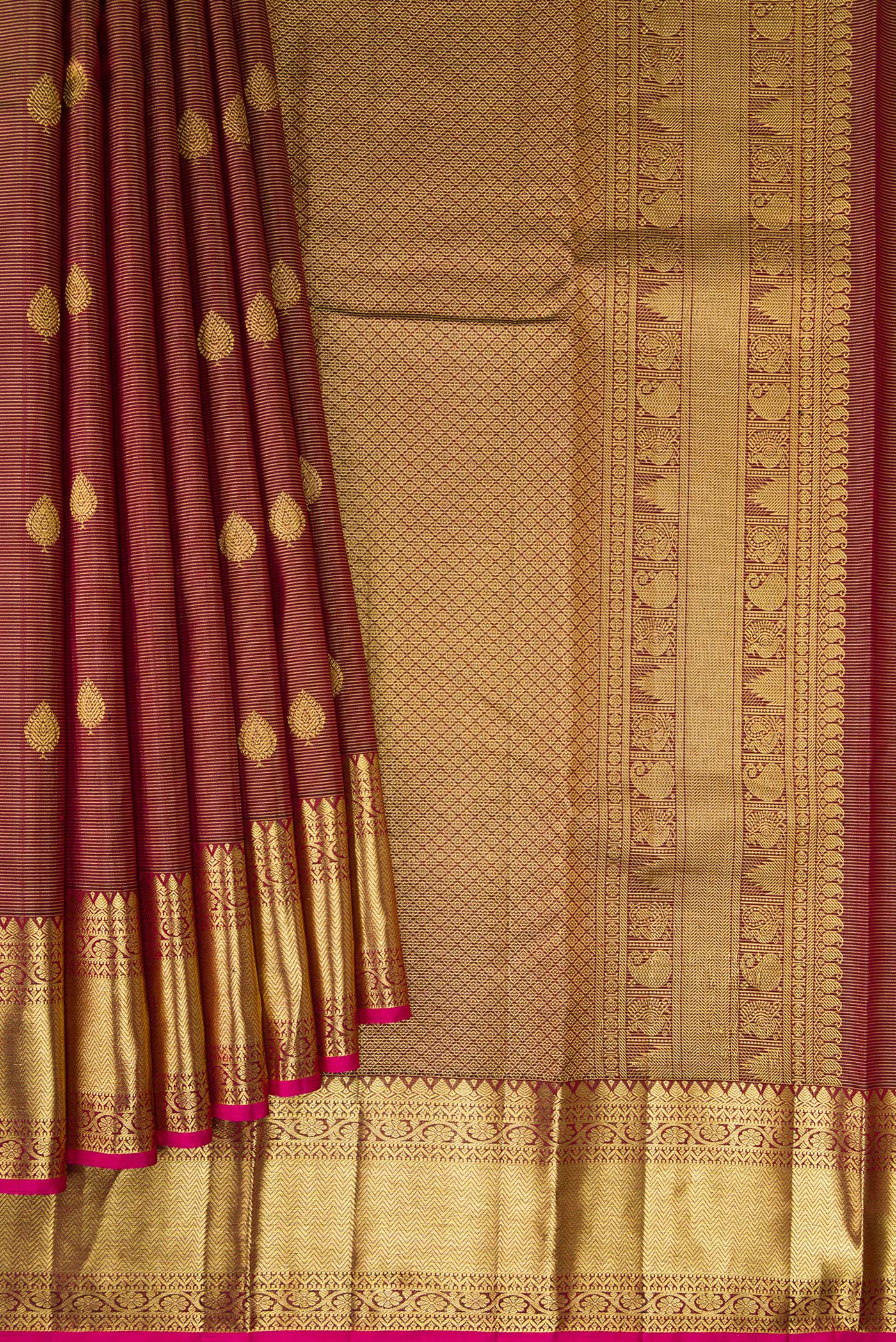 Pleats and pallu of Brown Dual Tone Kanchipuram Silk Saree with Stripes on the body and Zari Border. 