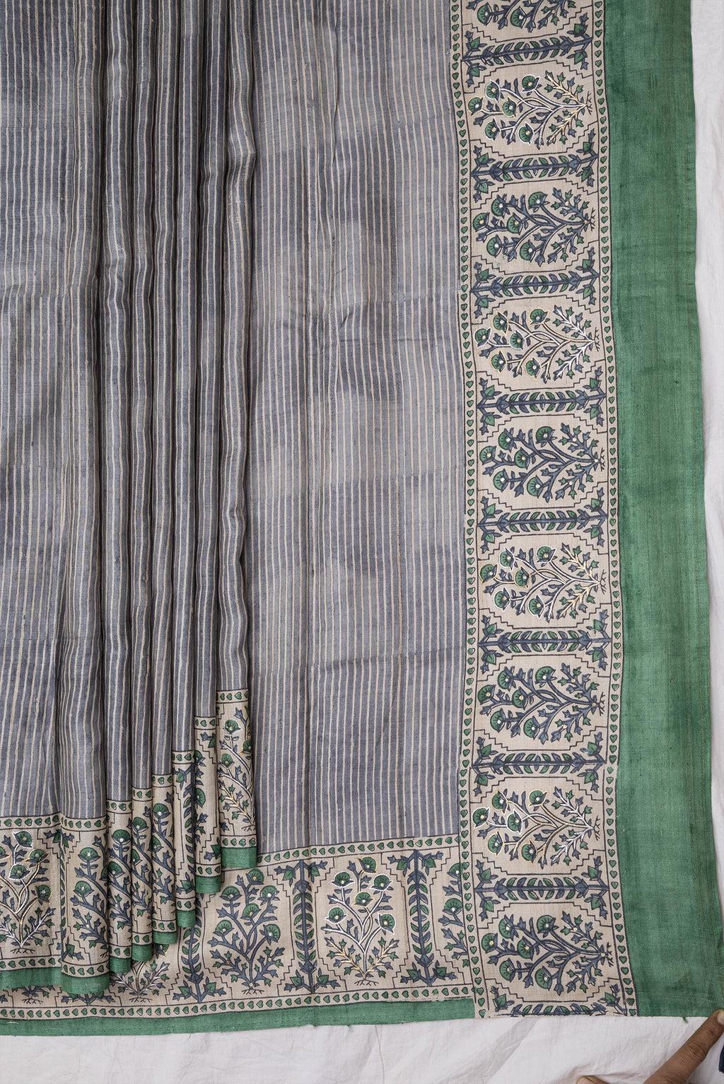 Pleats and pallu of Grey Dual Tone Tussar Silk Saree with Stripes on the body and Embroidery Border. 