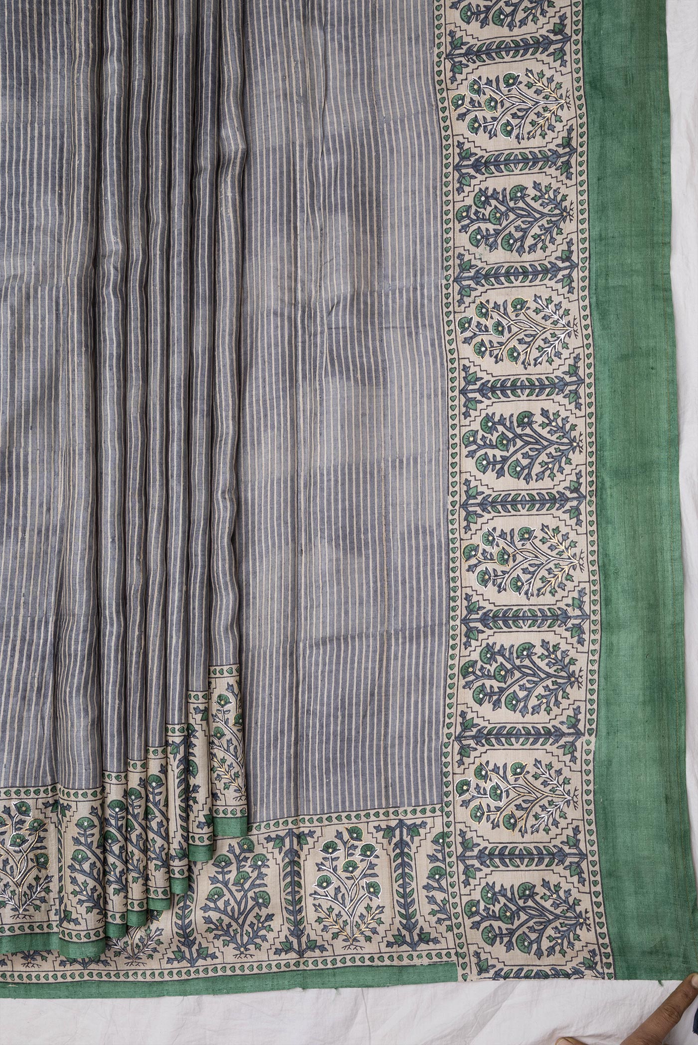 Pleats and pallu of Grey Dual Tone Tussar Silk Saree with Stripes on the body and Embroidery Border. 
