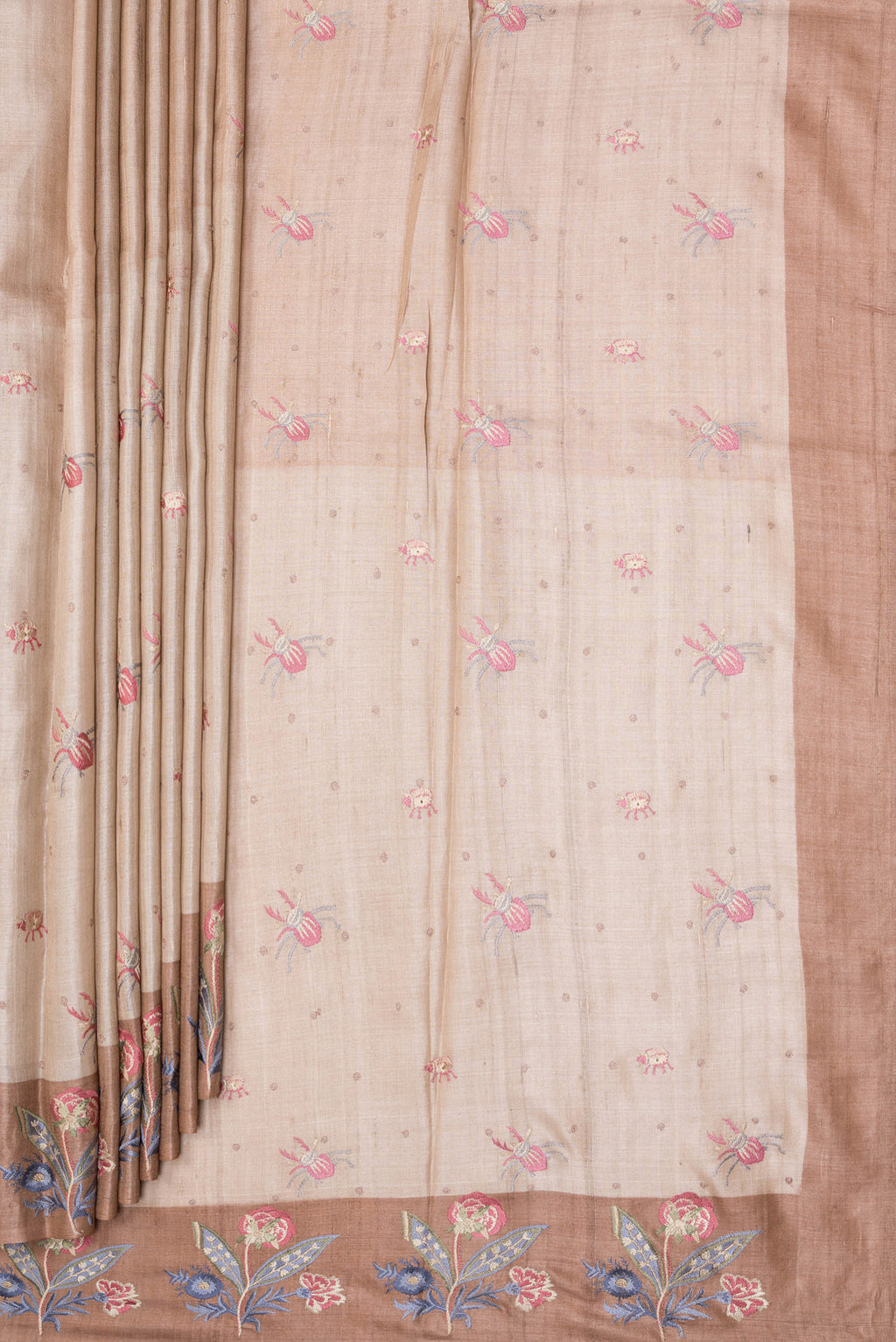 Pleats and pallu of Beige Tussar Silk Saree with Embroidery on the body and Embroidery Border. 