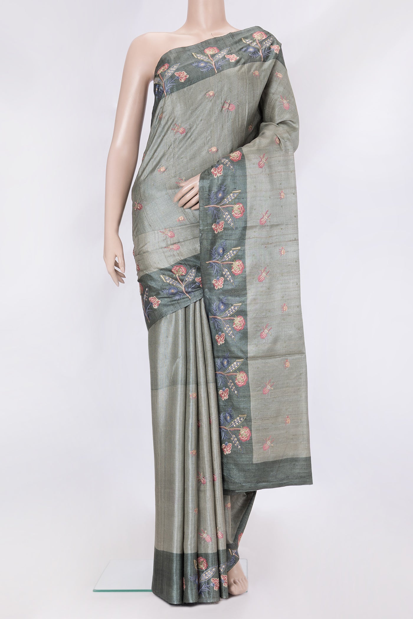 Grey Dual Tone Tussar Silk Saree with Thread Butta on the body and Embroidery Border.  displayed on a mannequin
