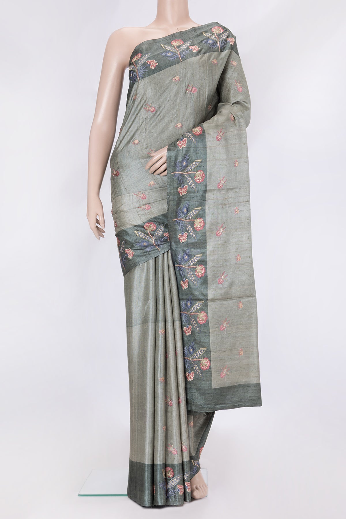 Grey Dual Tone Tussar Silk Saree with Thread Butta on the body and Embroidery Border.  displayed on a mannequin