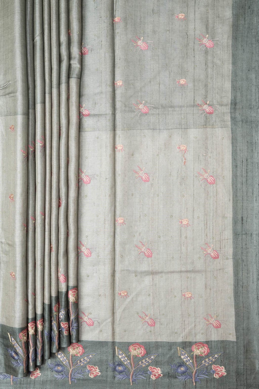 Pleats and pallu of Grey Dual Tone Tussar Silk Saree with Thread Butta on the body and Embroidery Border. 