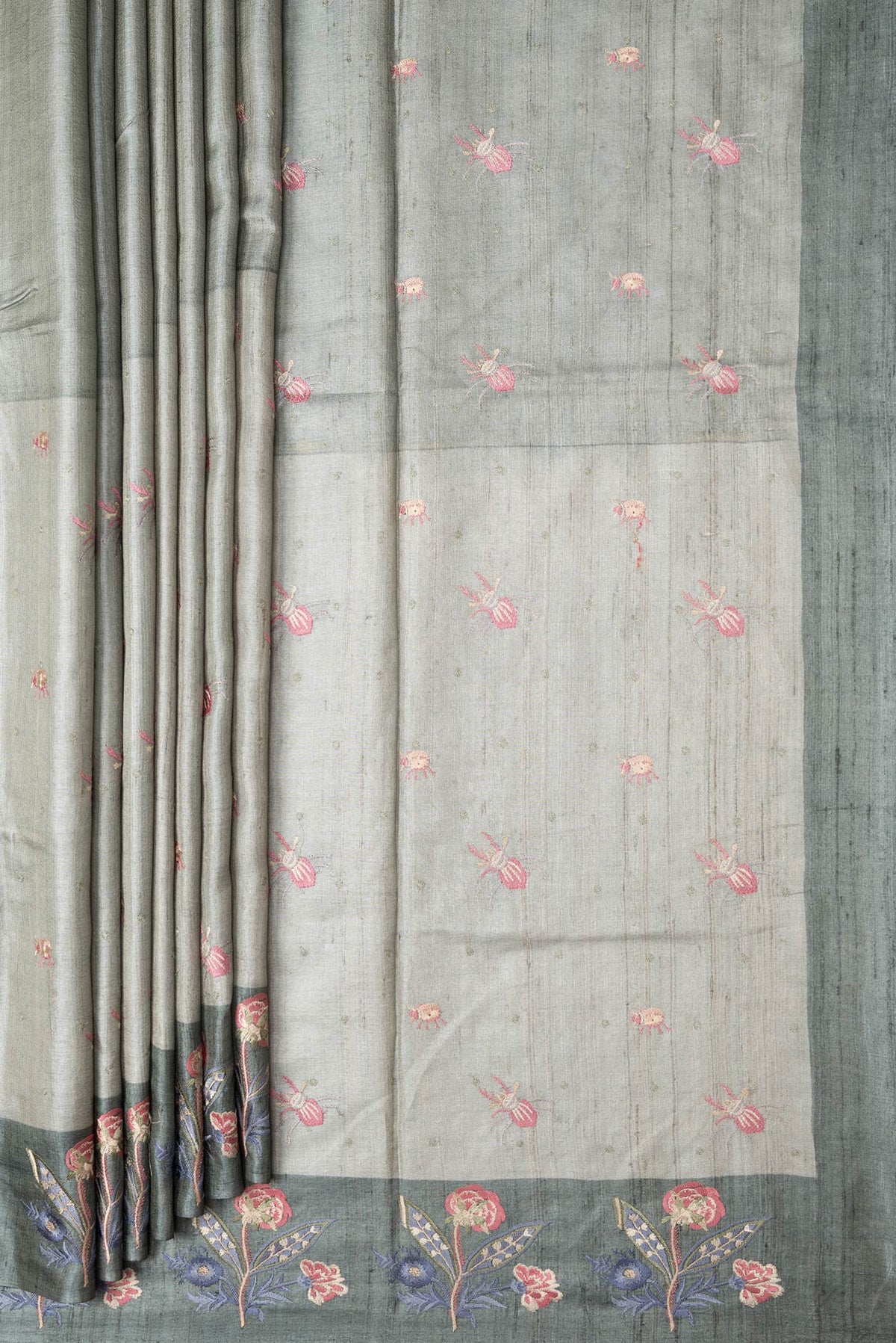 Pleats and pallu of Grey Dual Tone Tussar Silk Saree with Thread Butta on the body and Embroidery Border. 