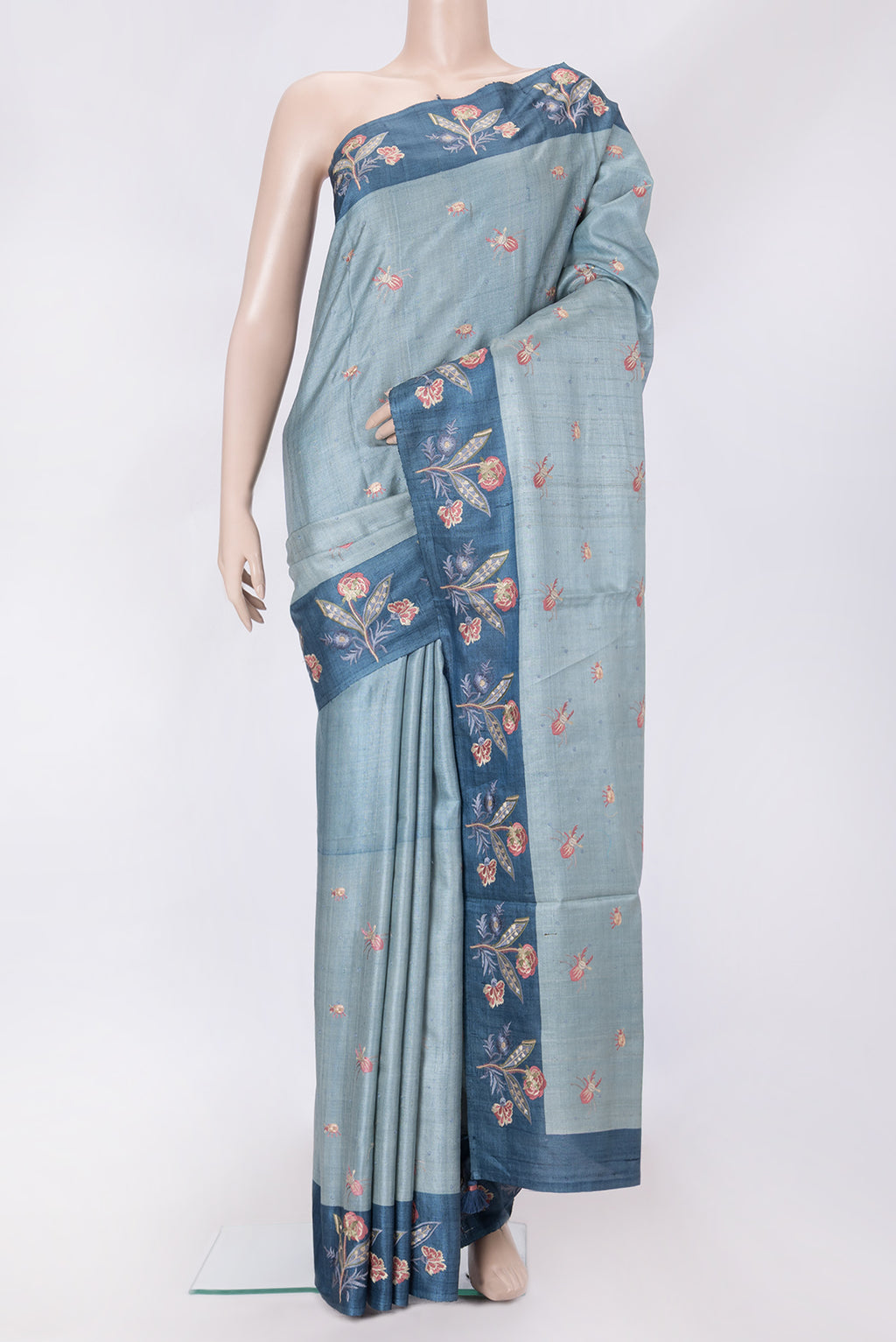 Grey Dual Tone Tussar Silk Saree with Thread Butta on the body and Embroidery Border.  displayed on a mannequin