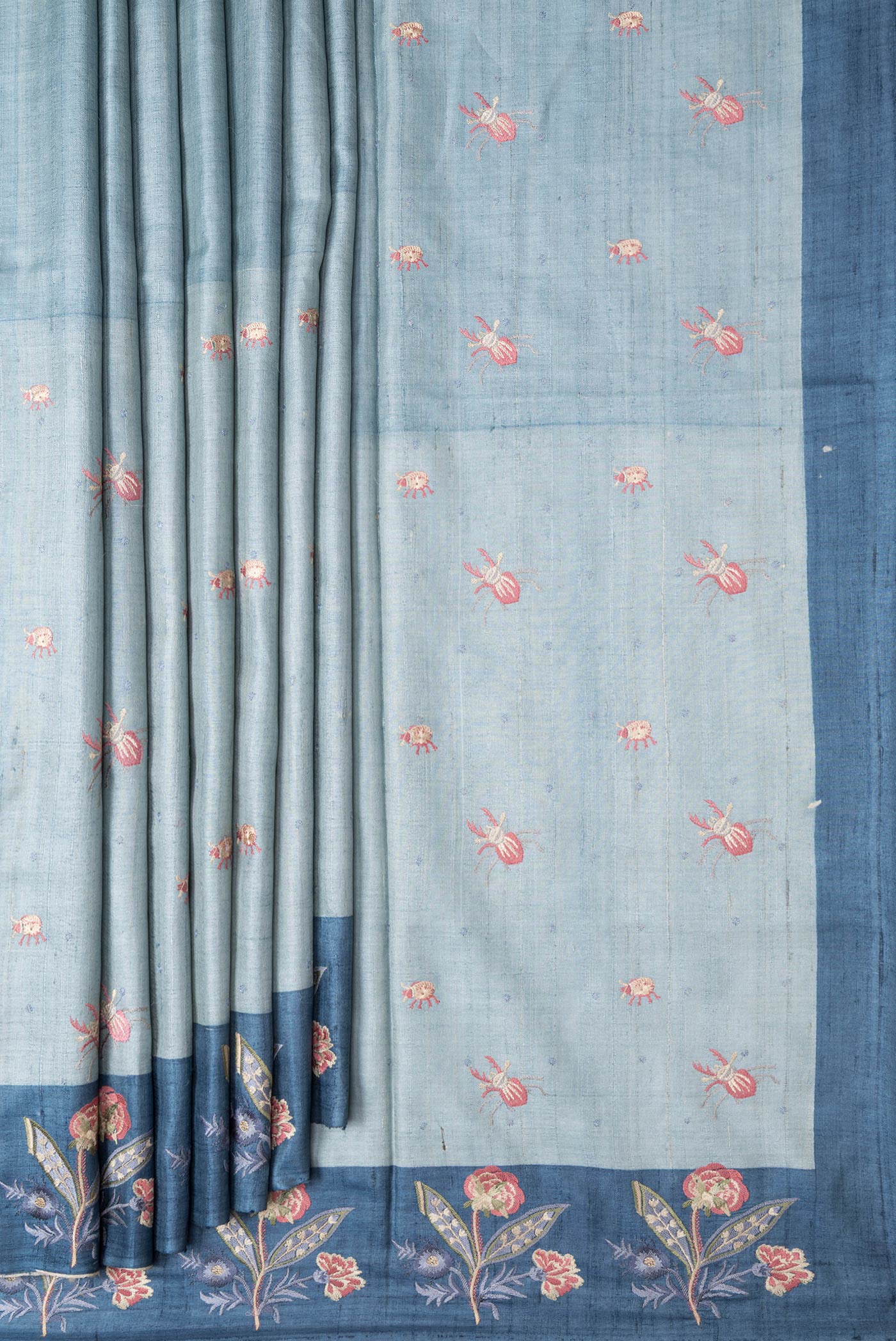 Pleats and pallu of Grey Dual Tone Tussar Silk Saree with Thread Butta on the body and Embroidery Border. 