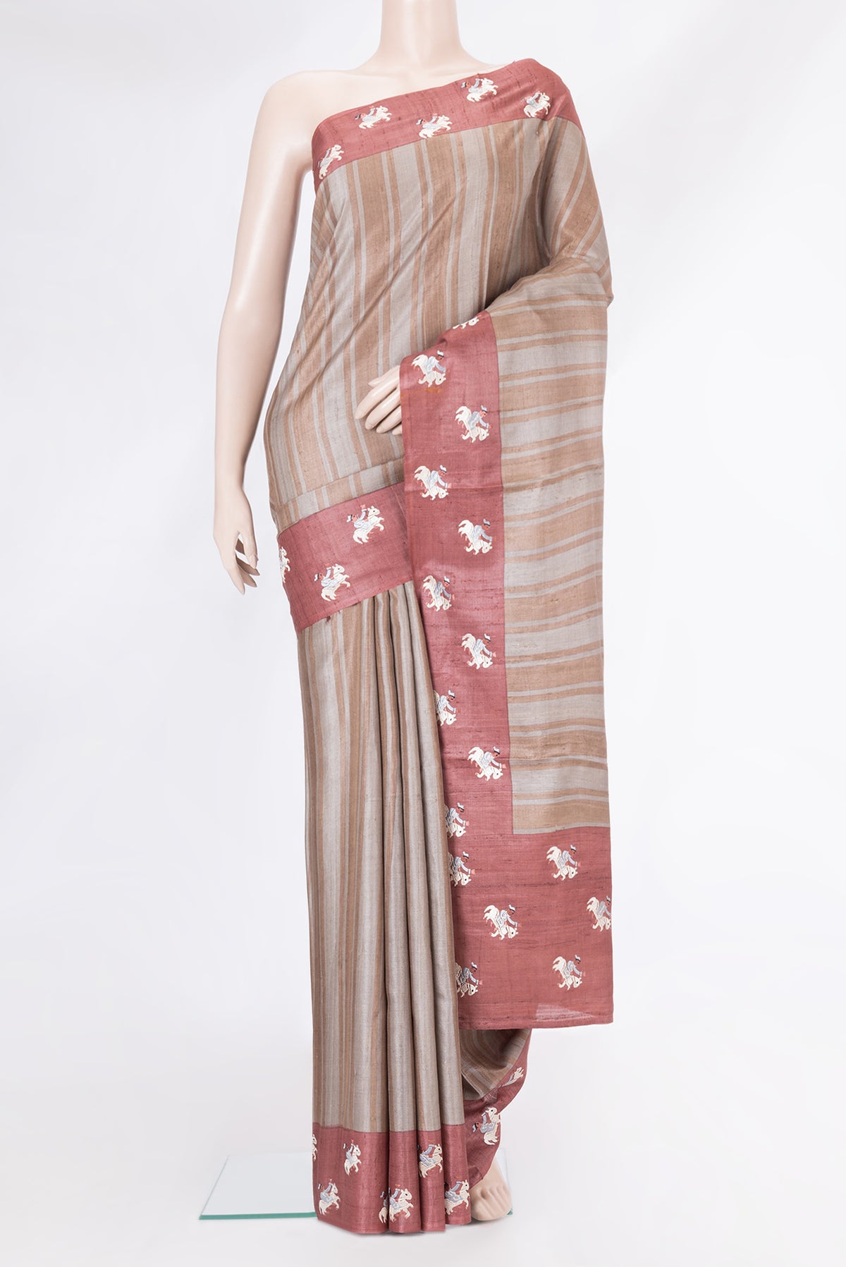 Grey Dual Tone Tussar Silk Saree with Stripes on the body and Embroidery Border.  displayed on a mannequin
