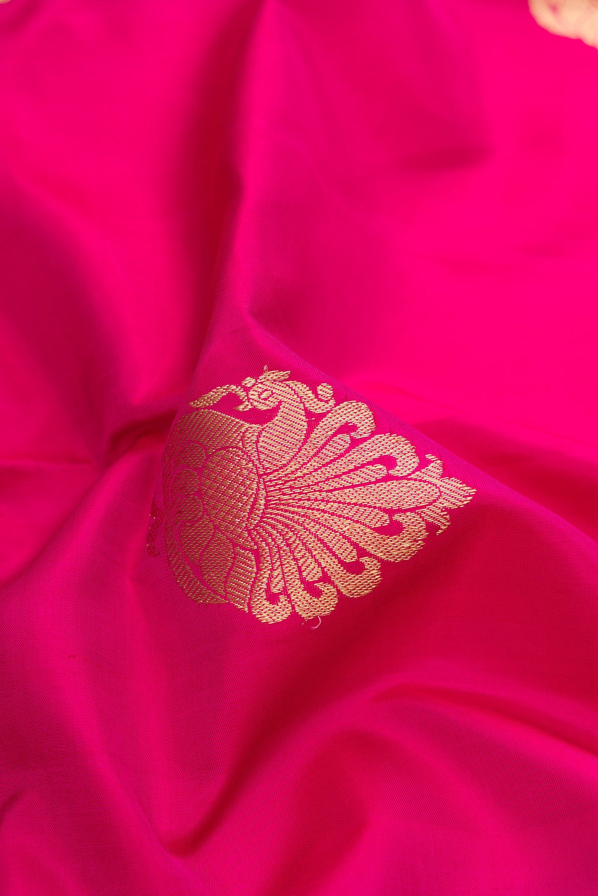 Close up of Pink Kanjivaram Silk Saree with Zari Butta on the body and Zari Border.  displaying folds