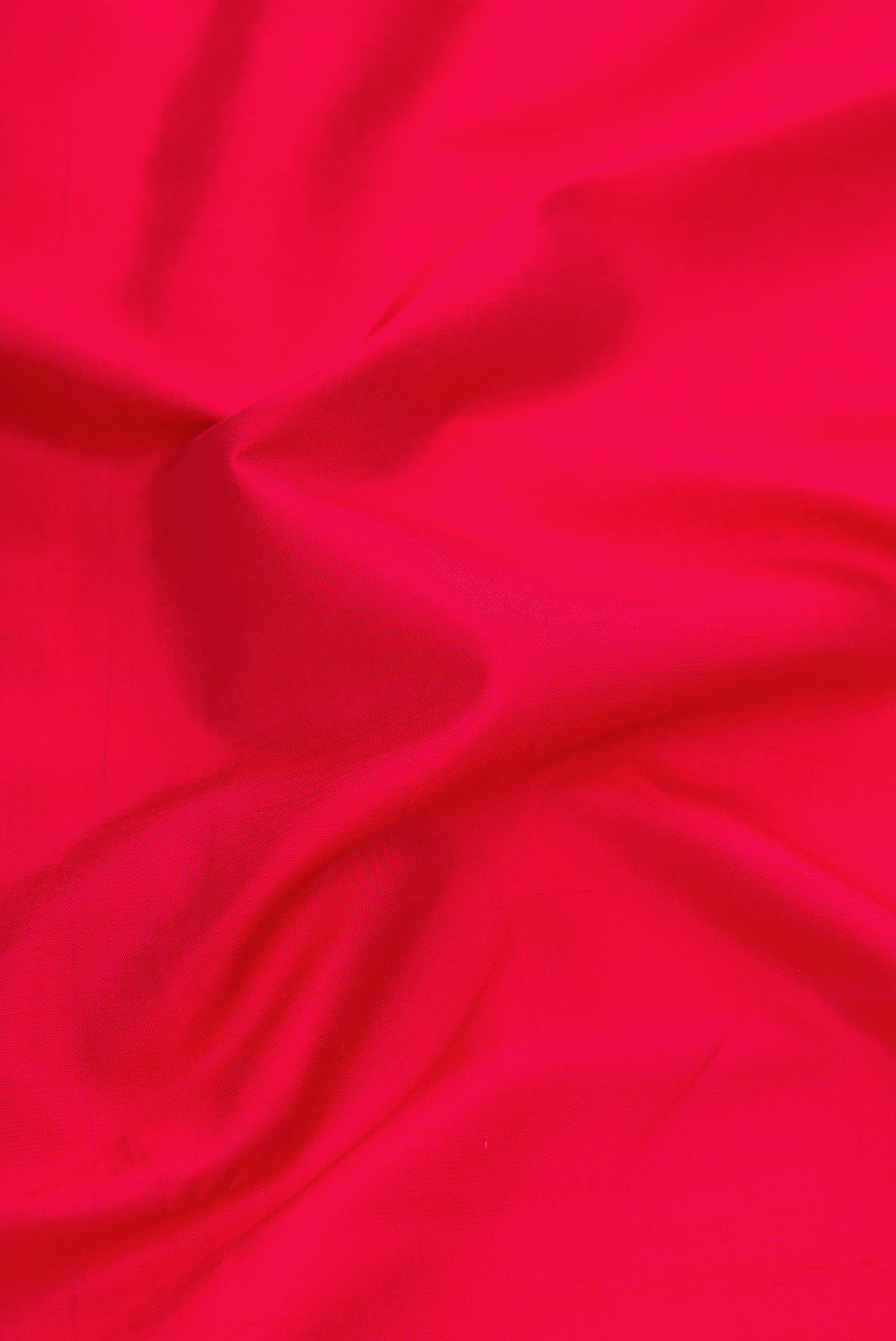 Close up of Red Dual Tone Kanchipuram Silk Saree with Plain Body and Thread Border.  displaying folds