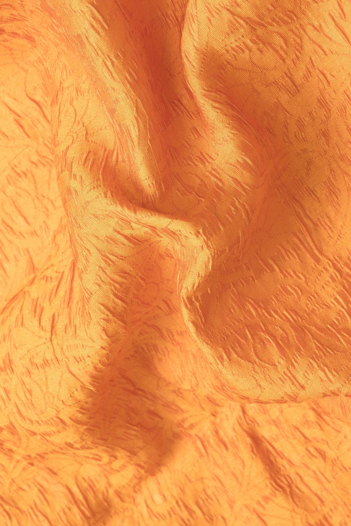 Close up of Orange Dual Tone Tussar Silk Saree with Jacquard design on the body and Zari Border.  displaying folds