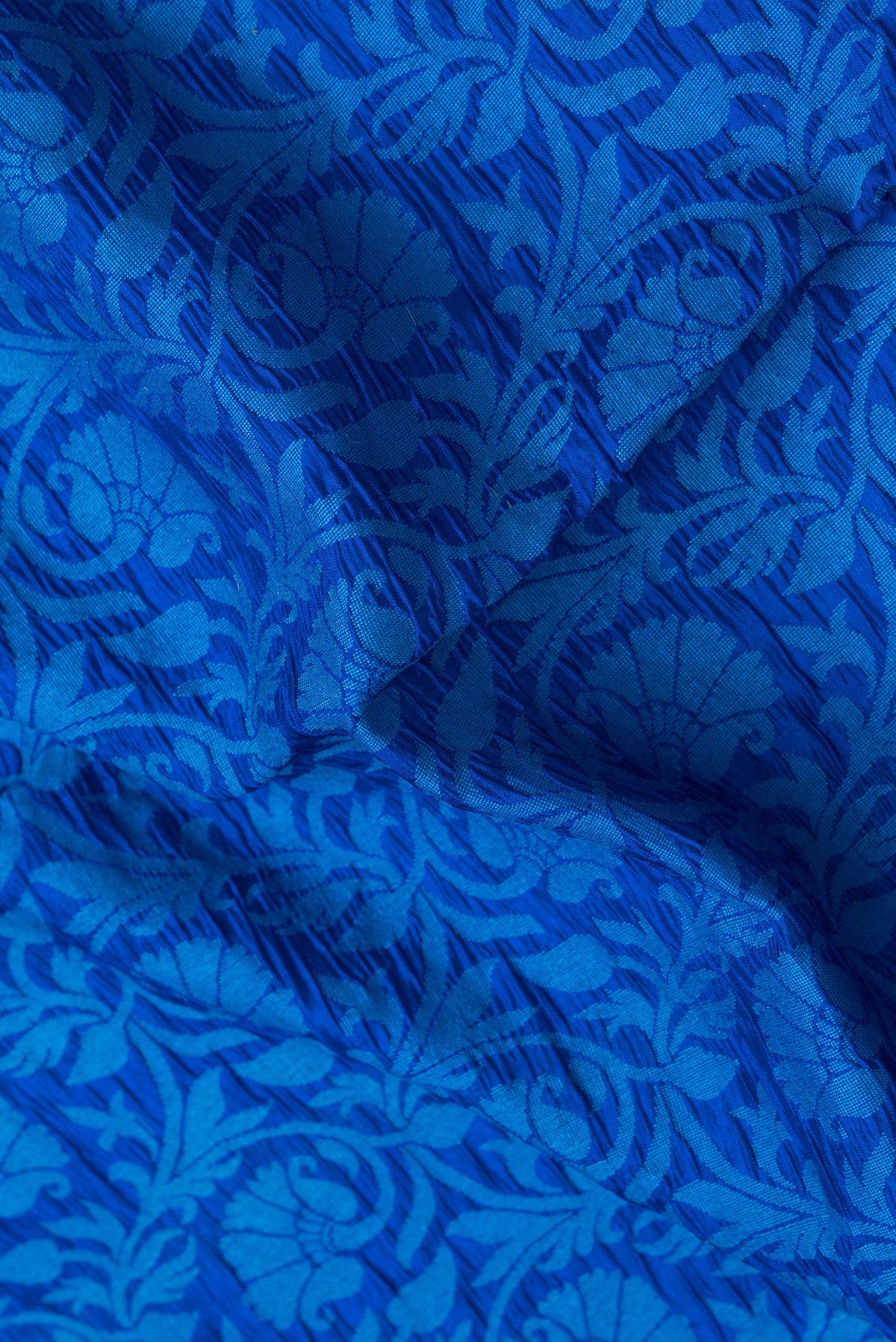 Close up of Royal Blue Dual Tone Tussar Silk Saree with Jacquard design on the body and Zari Border.  displaying folds