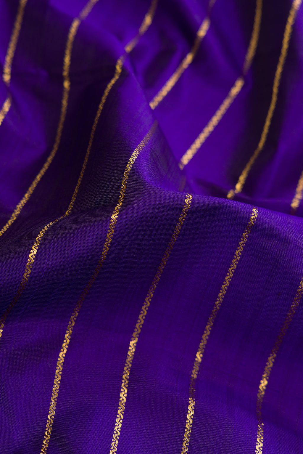 Close up of Royal Blue Dual Tone Kanjivaram Silk Saree with Stripes on the body and Zari Border.  displaying folds