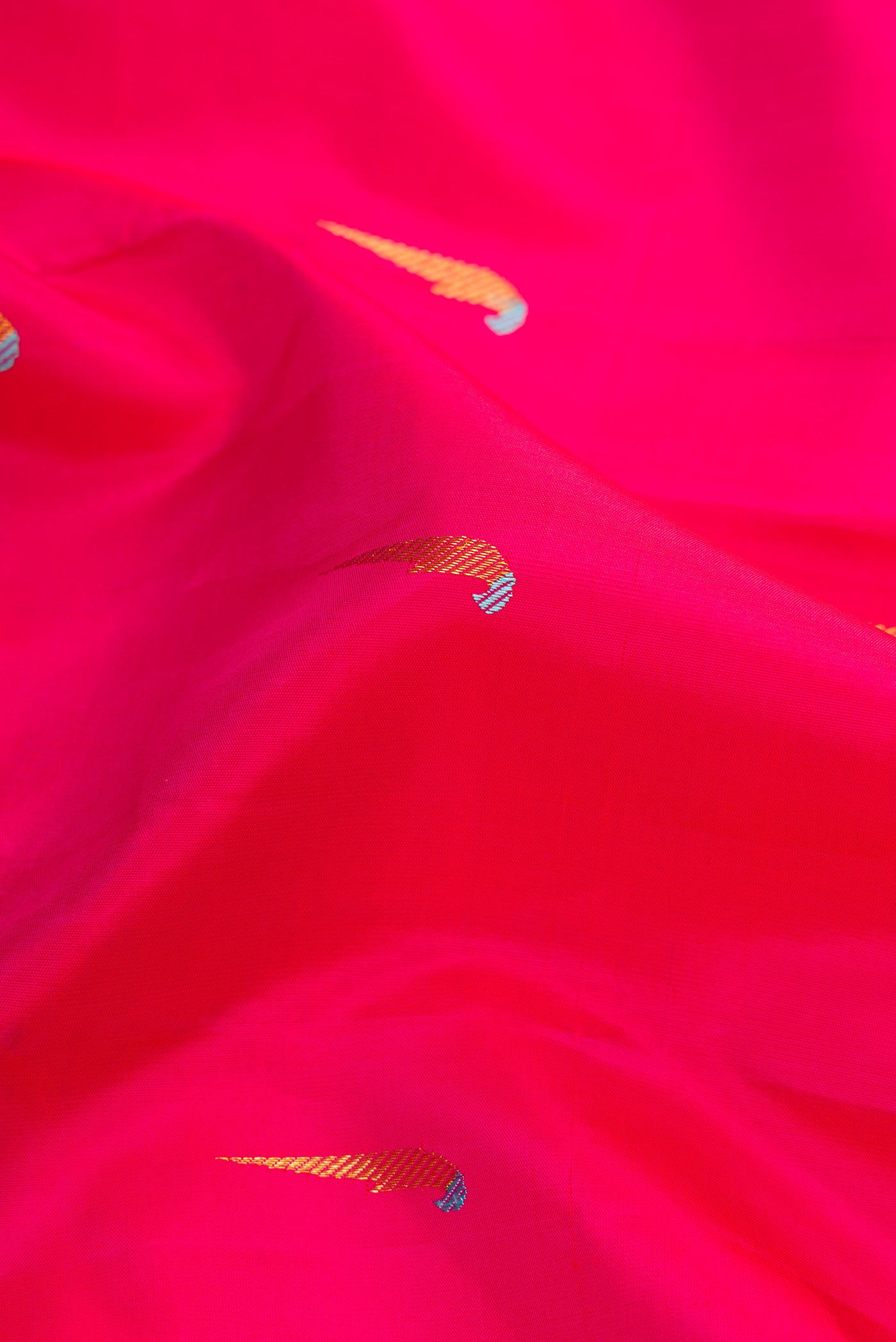 Close up of Pure Silk Pure Zari Pink Dual Tone Kanjivaram Saree with Zari And Thread Butta on the body and Thin Zari Line.  displaying folds