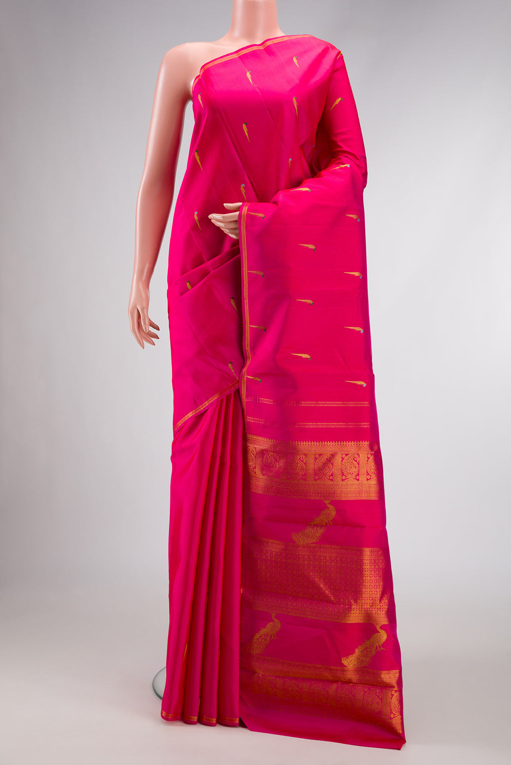 Pure Silk Pure Zari Pink Dual Tone Kanjivaram Saree with Zari And Thread Butta on the body and Thin Zari Line.  displayed on a mannequin