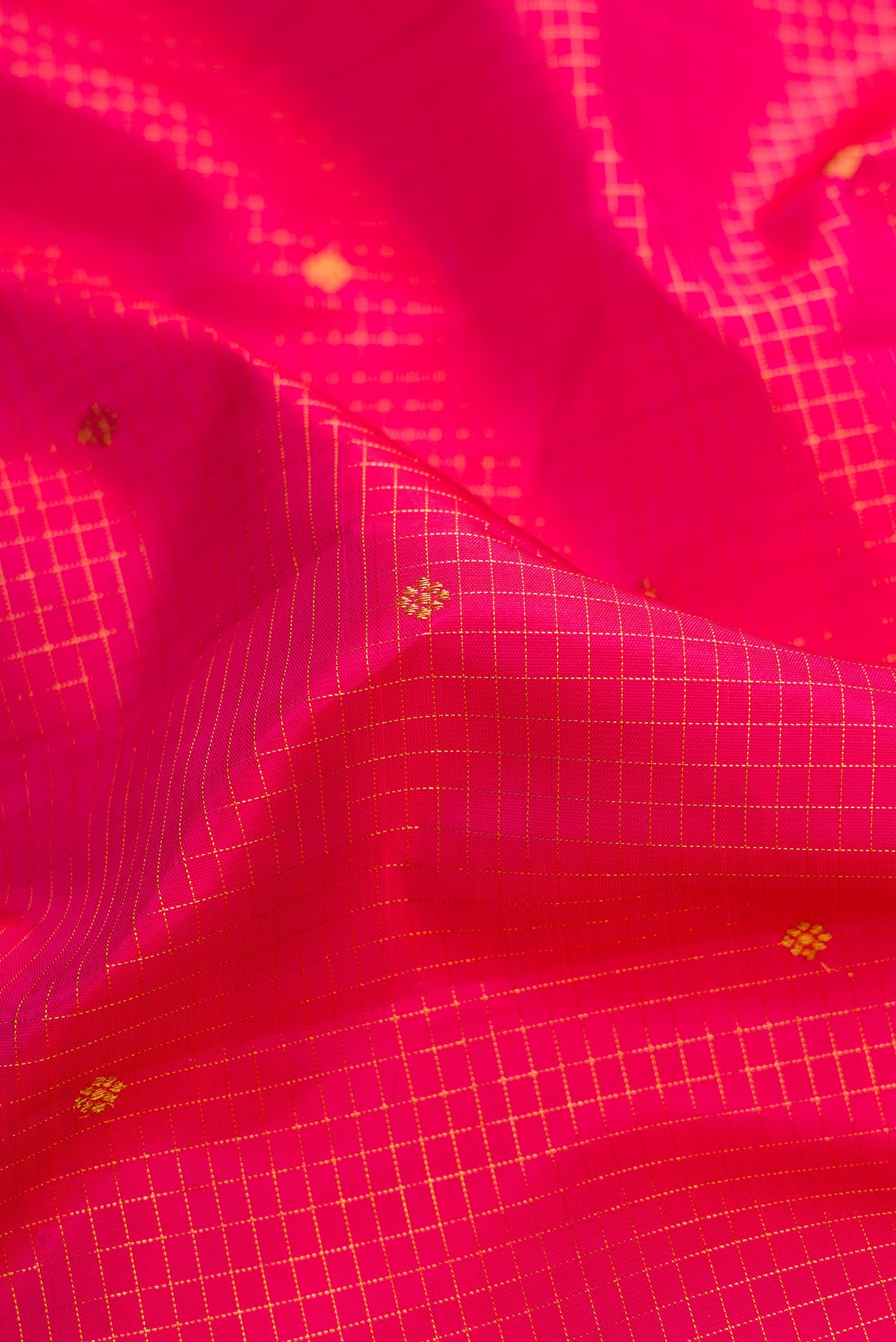 Close up of Pure Silk Pure Zari Dark Pink Dual Tone Kanchipuram Saree with Stripes on the body and Zari Border.  displaying folds