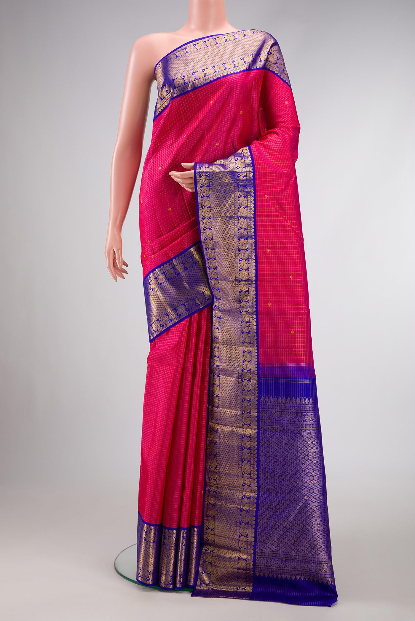 Pure Silk Pure Zari Dark Pink Dual Tone Kanchipuram Saree with Stripes on the body and Zari Border.  displayed on a mannequin
