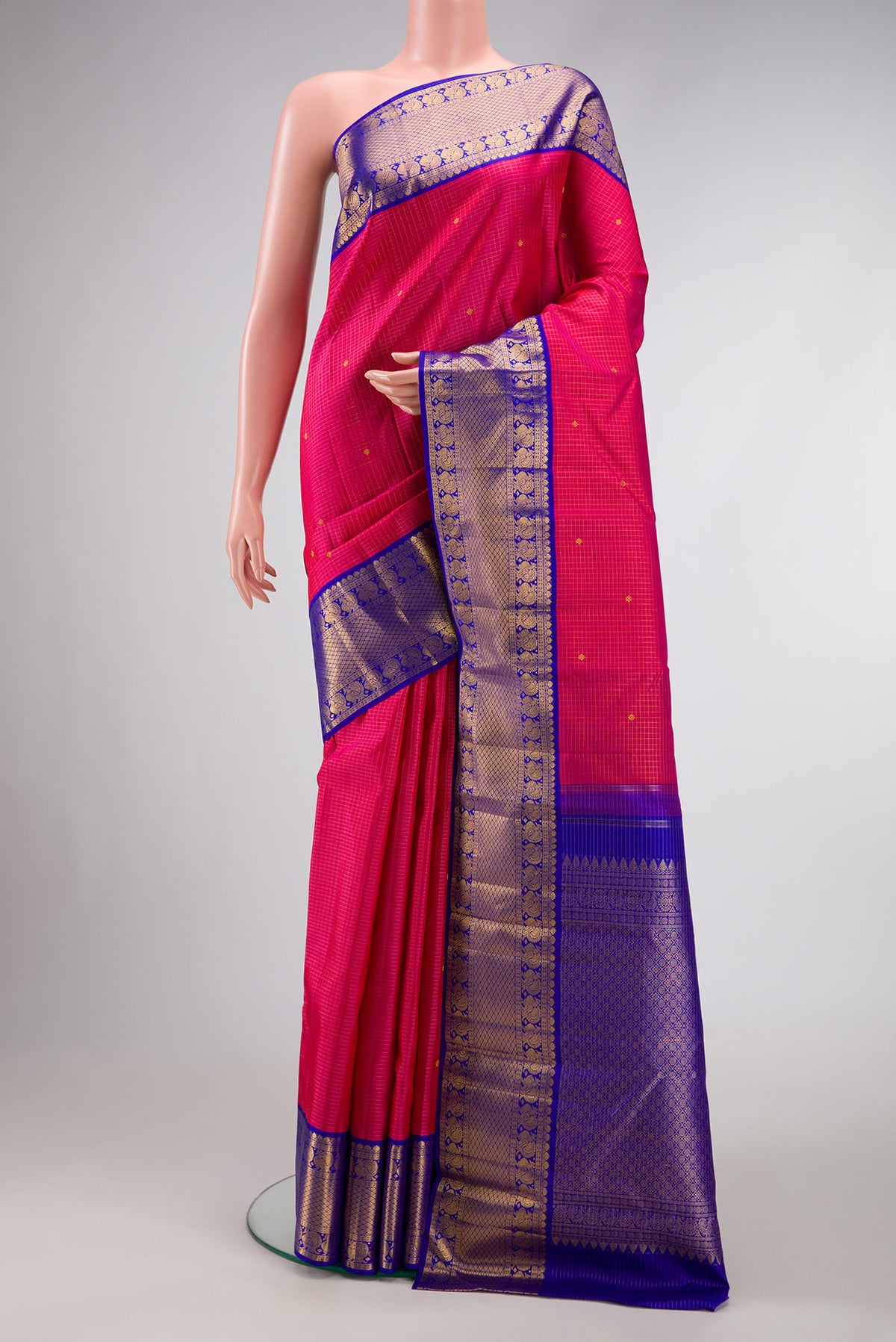 Pure Silk Pure Zari Dark Pink Dual Tone Kanchipuram Saree with Stripes on the body and Zari Border.  displayed on a mannequin
