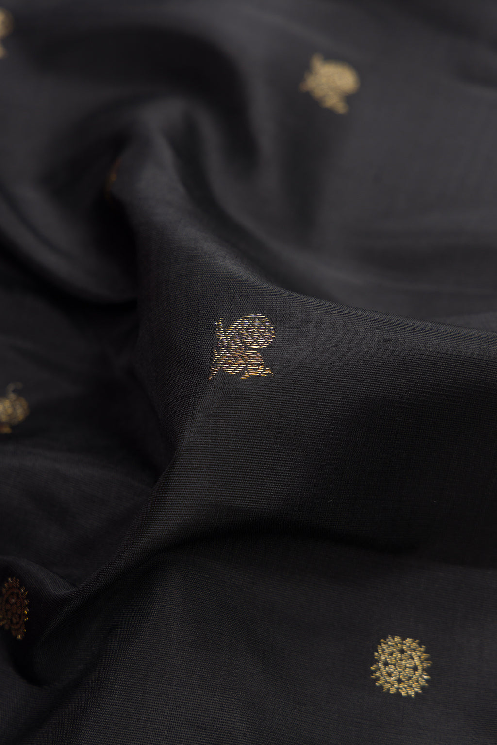 Close up of Pure Silk Pure Zari Coffee Brown Dual Tone Kanjivaram Saree with Zari Butta on the body and Zari Border.  displaying folds