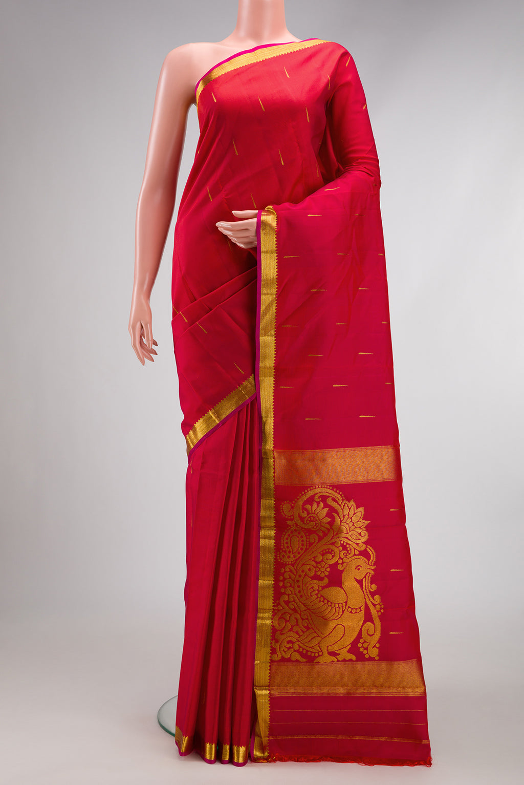 Red Kanjivaram Silk Saree with Zari Butta on the body and Zari Border.  displayed on a mannequin