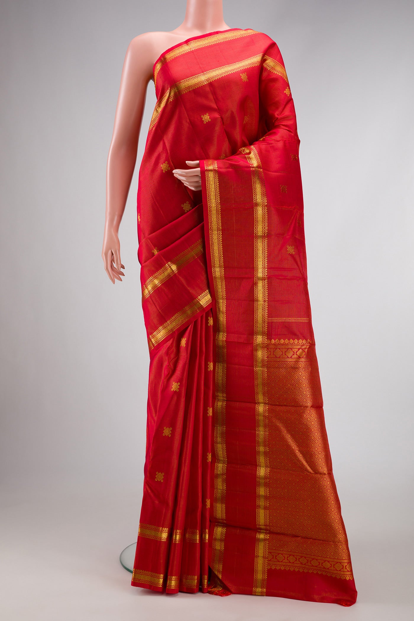 Pure Silk Pure Zari Red Dual Tone Kanjivaram Saree with Stripes on the body and Zari Border.  displayed on a mannequin
