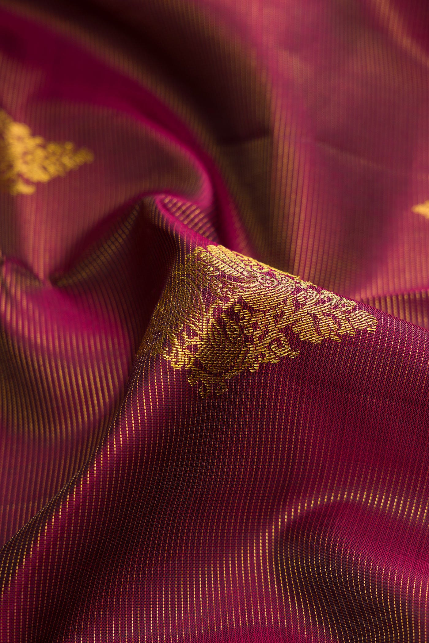 Close up of Burgundy Dual Tone Kanjivaram Silk Saree with Stripes on the body and Thin Zari Line.  displaying folds