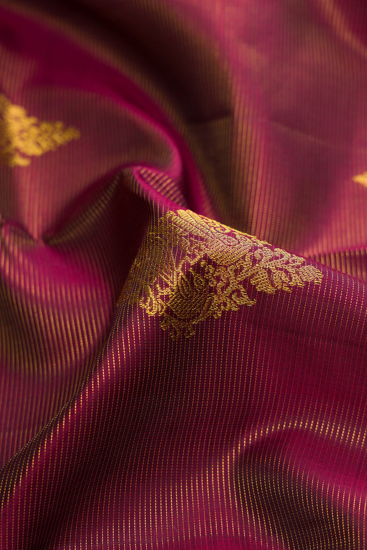 Close up of Burgundy Dual Tone Kanjivaram Silk Saree with Stripes on the body and Thin Zari Line.  displaying folds