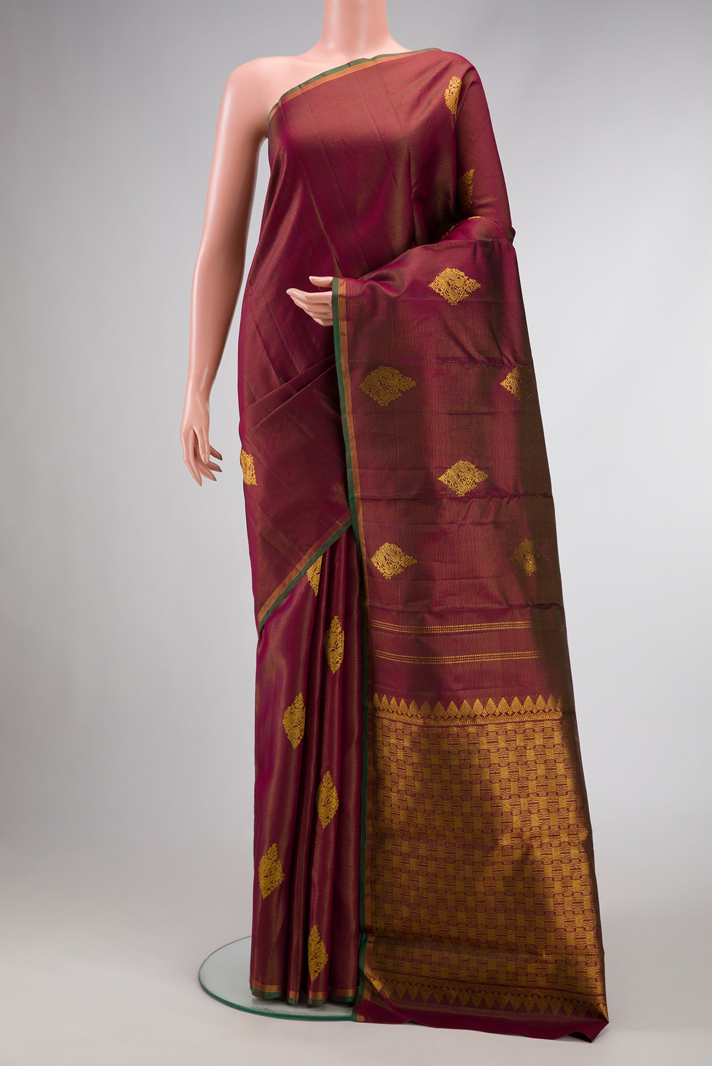 Burgundy Dual Tone Kanjivaram Silk Saree with Stripes on the body and Thin Zari Line.  displayed on a mannequin