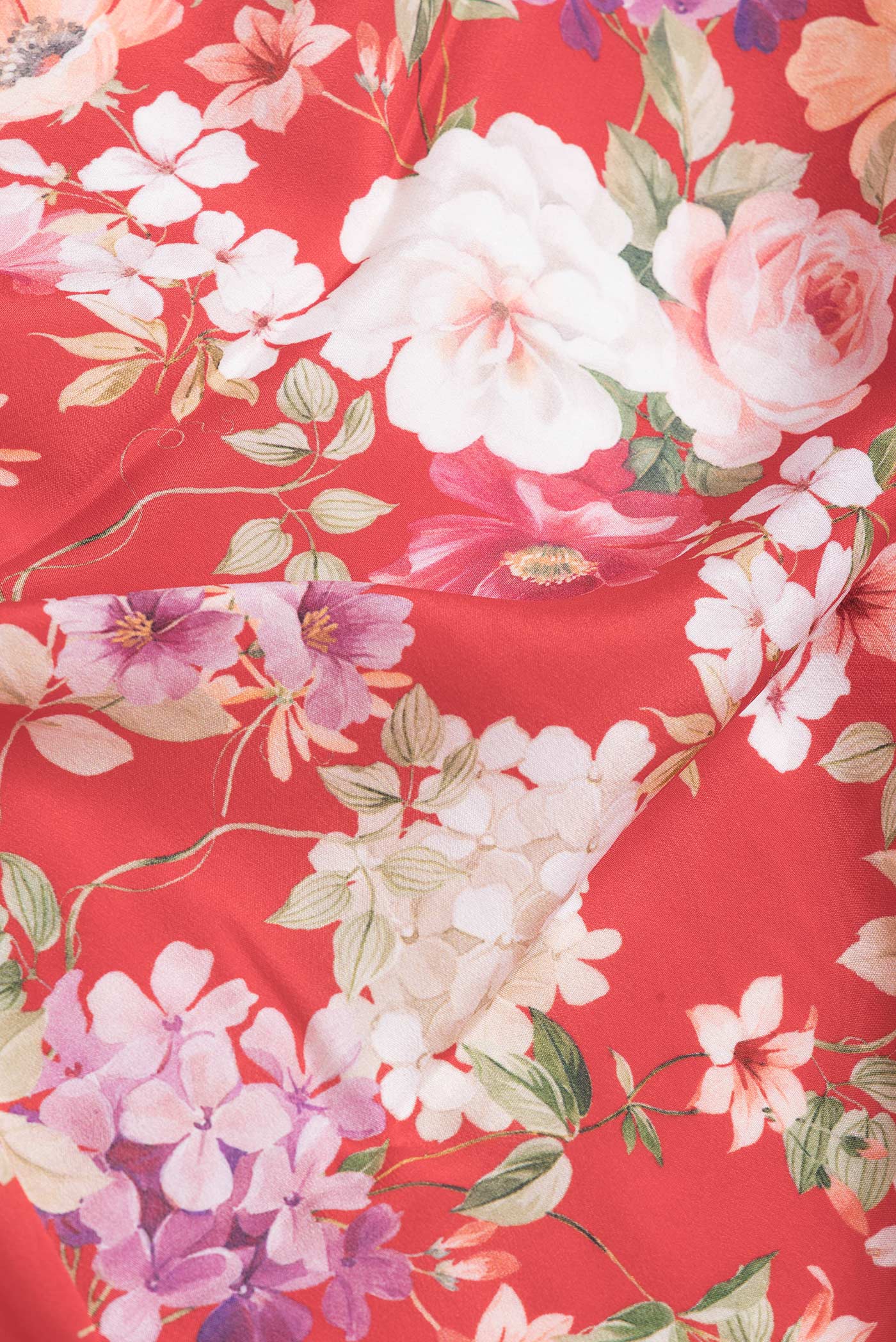 Close up of Red Dual Tone Mysore Crepe Saree with Printed design on the body and Zari Border.  displaying folds