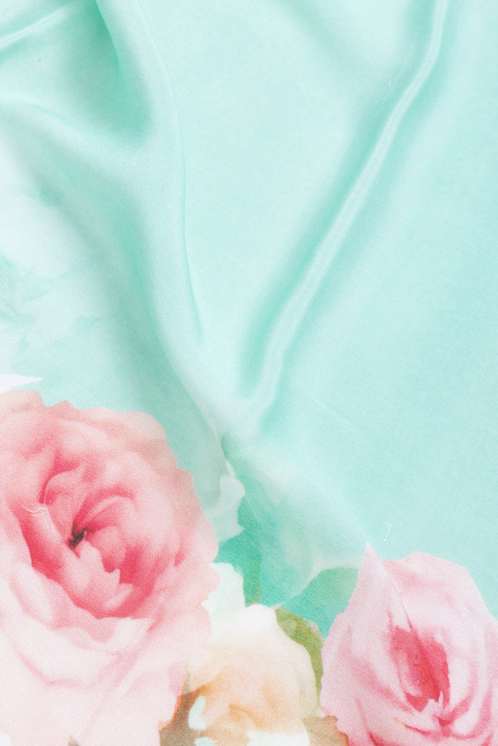 Close up of Green Dual Tone Mysore Crepe Saree with Printed design on the body and Zari Border.  displaying folds