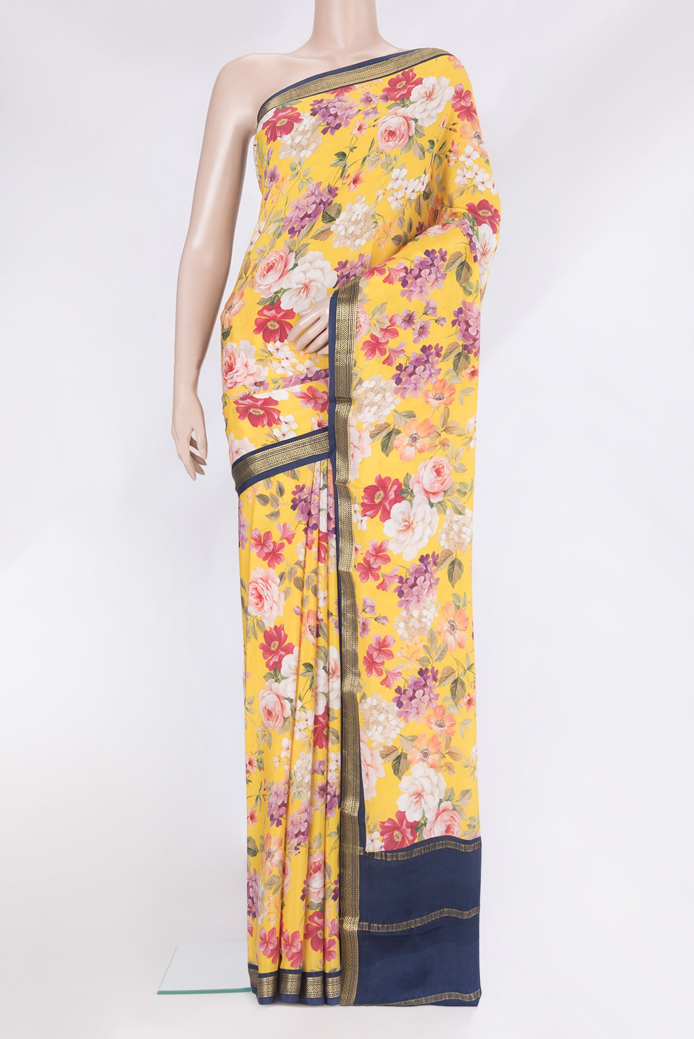Yellow Crepe Saree with Printed design on the body and Zari Border.  displayed on a mannequin