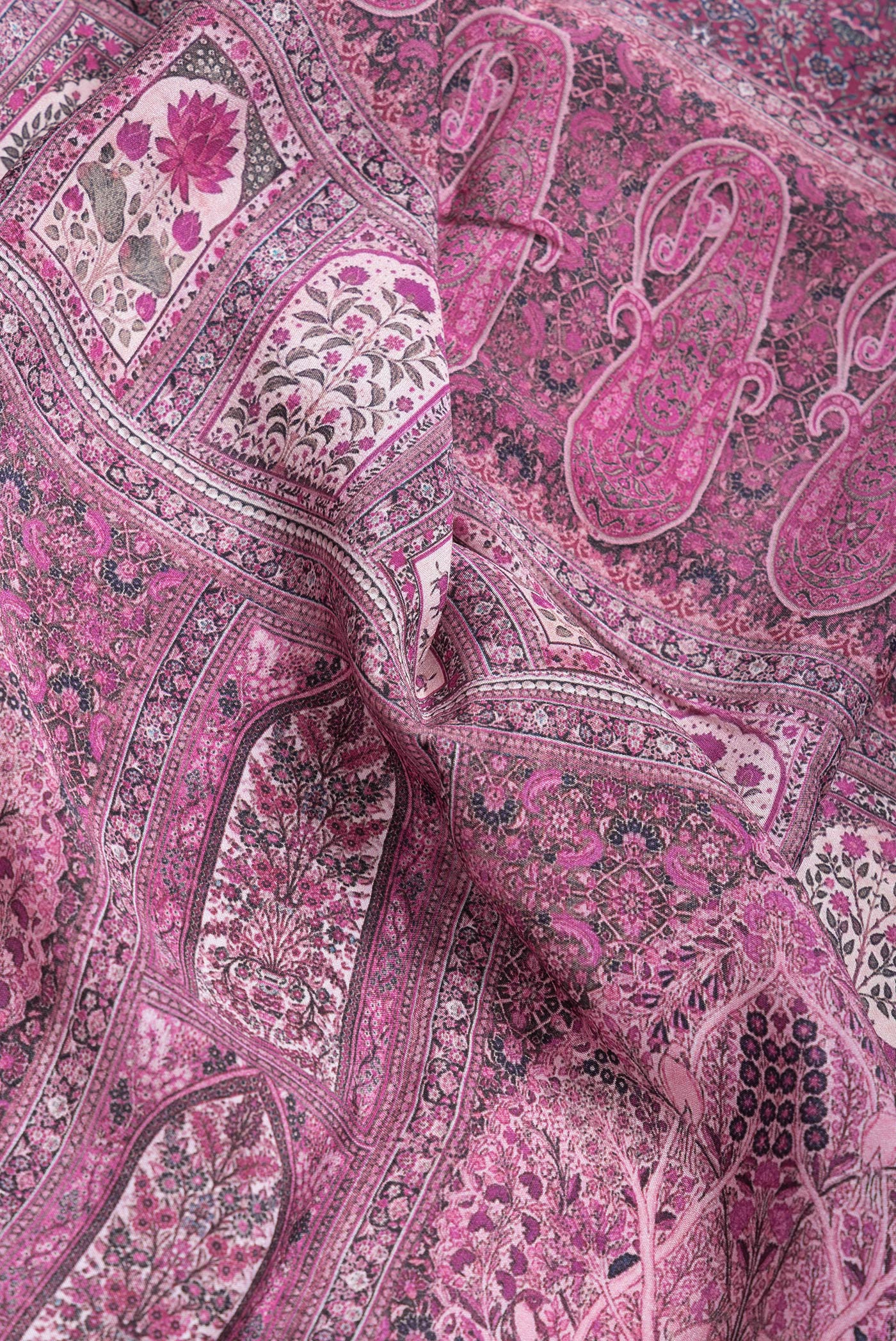 Close up of Magenta Dual Tone Mysore Crepe Saree with Printed design on the body and Zari Border.  displaying folds
