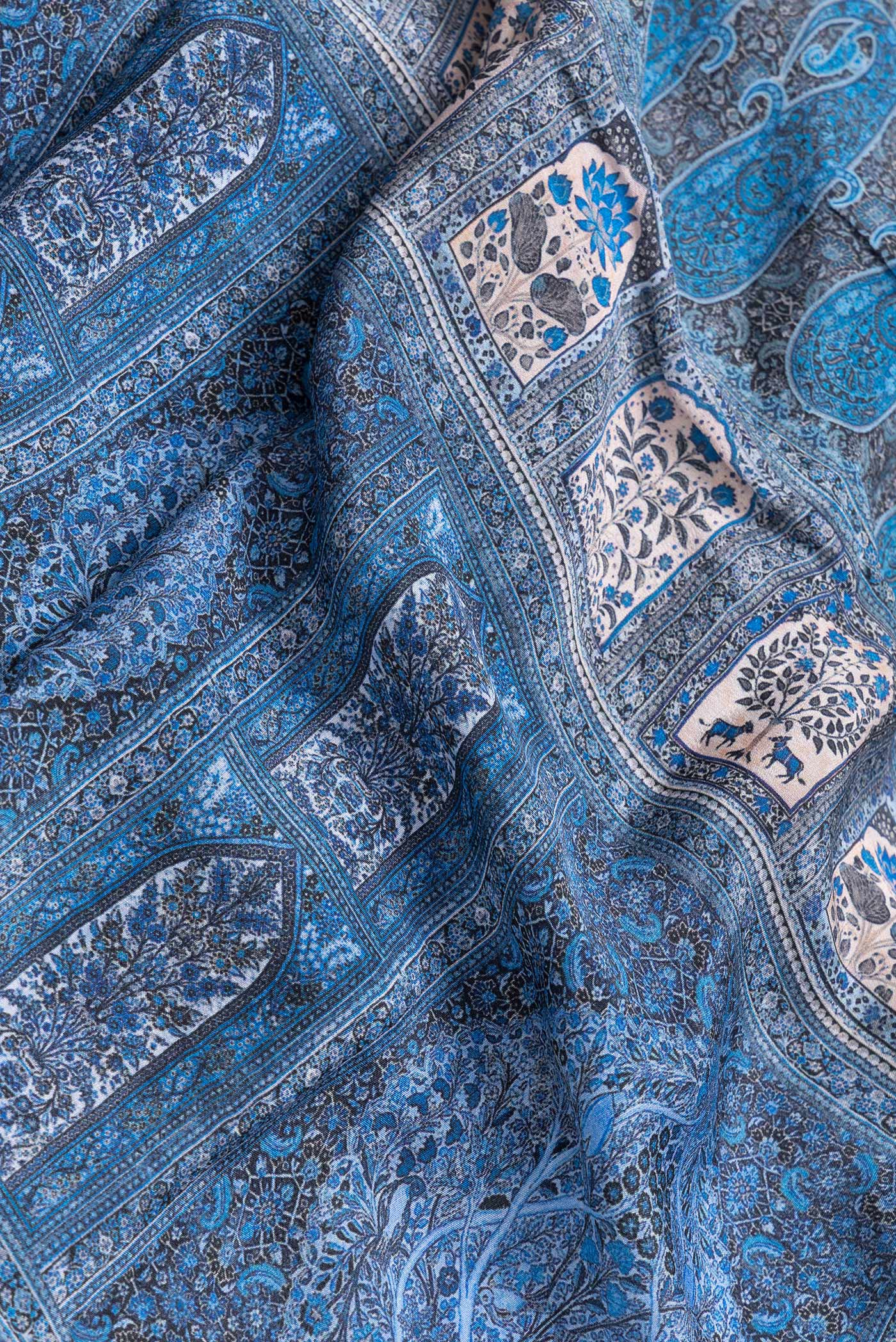 Close up of Navy Blue Dual Tone Mysore Crepe Saree with Printed design on the body and Zari Border.  displaying folds