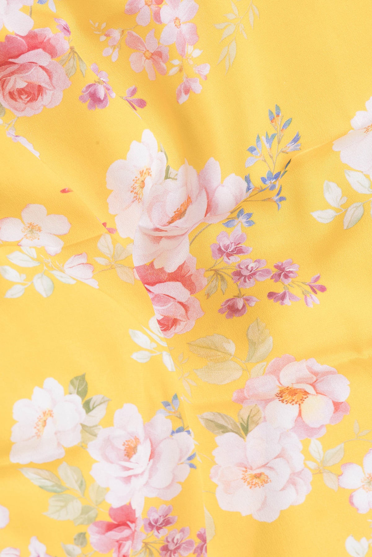 Close up of Yellow Mysore Crepe Saree with Floral Print on the body and Zari Border.  displaying folds