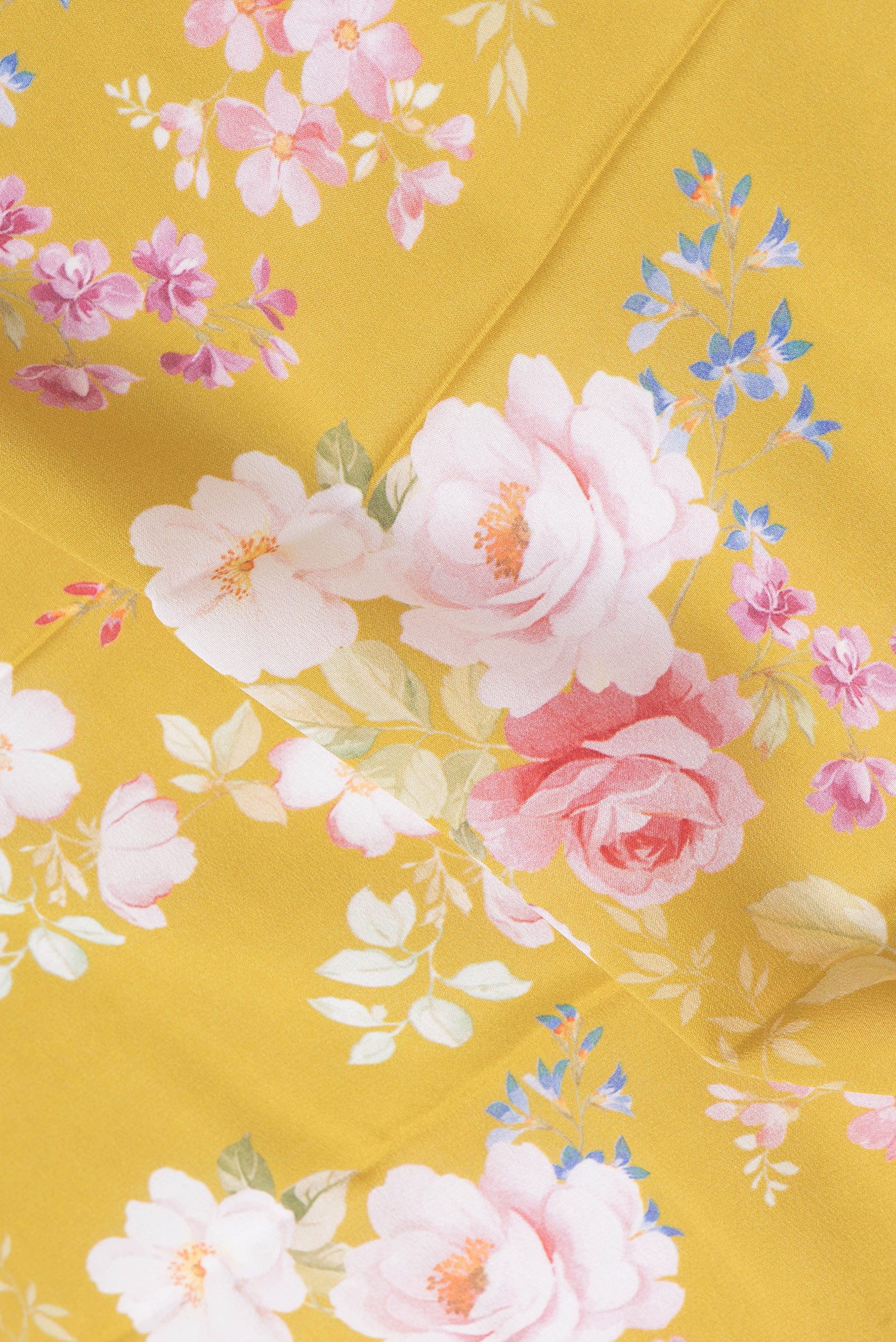 Close up of Mustard Mysore Crepe Saree with Floral Print on the body and Zari Border.  displaying folds