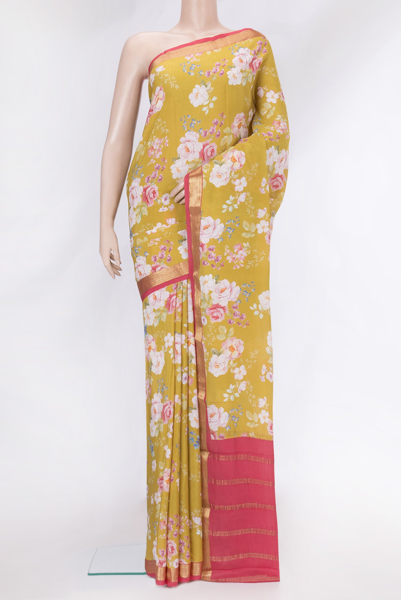 Mustard Mysore Crepe Saree with Floral Print on the body and Zari Border.  displayed on a mannequin