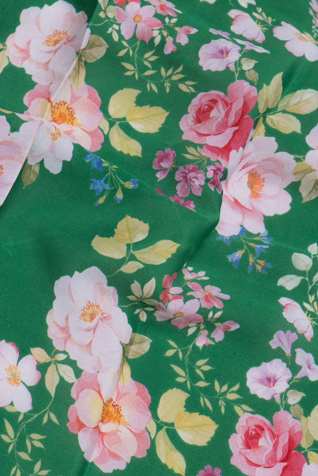 Close up of Green Mysore Silk Saree with Floral Print on the body and Zari Border.  displaying folds