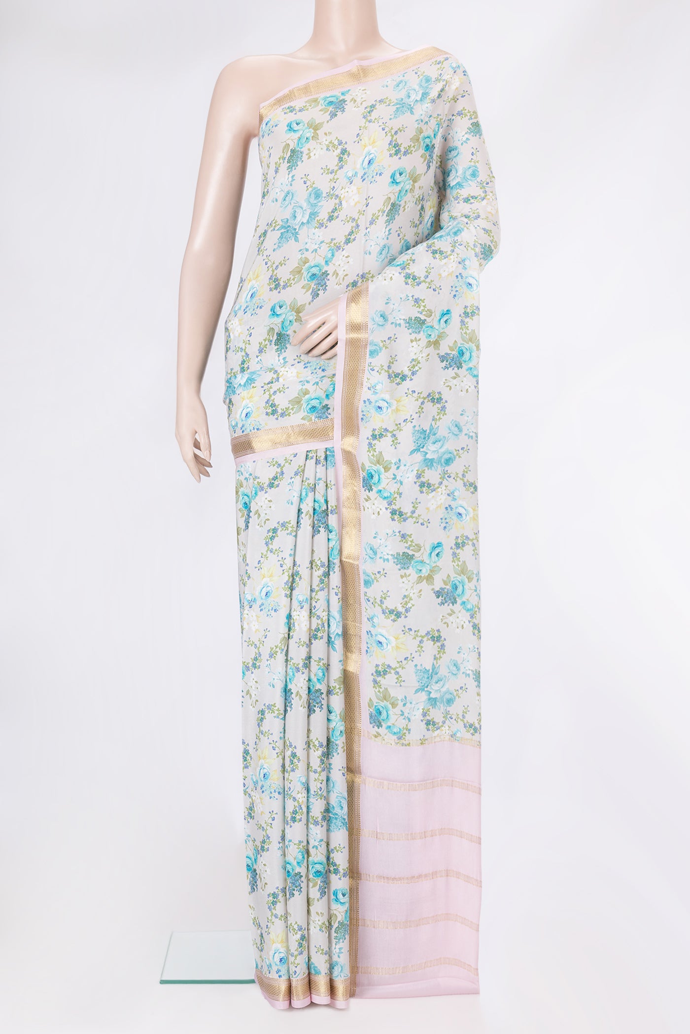 Off White Dual Tone Crepe Saree with Printed design on the body and Zari Border.  displayed on a mannequin