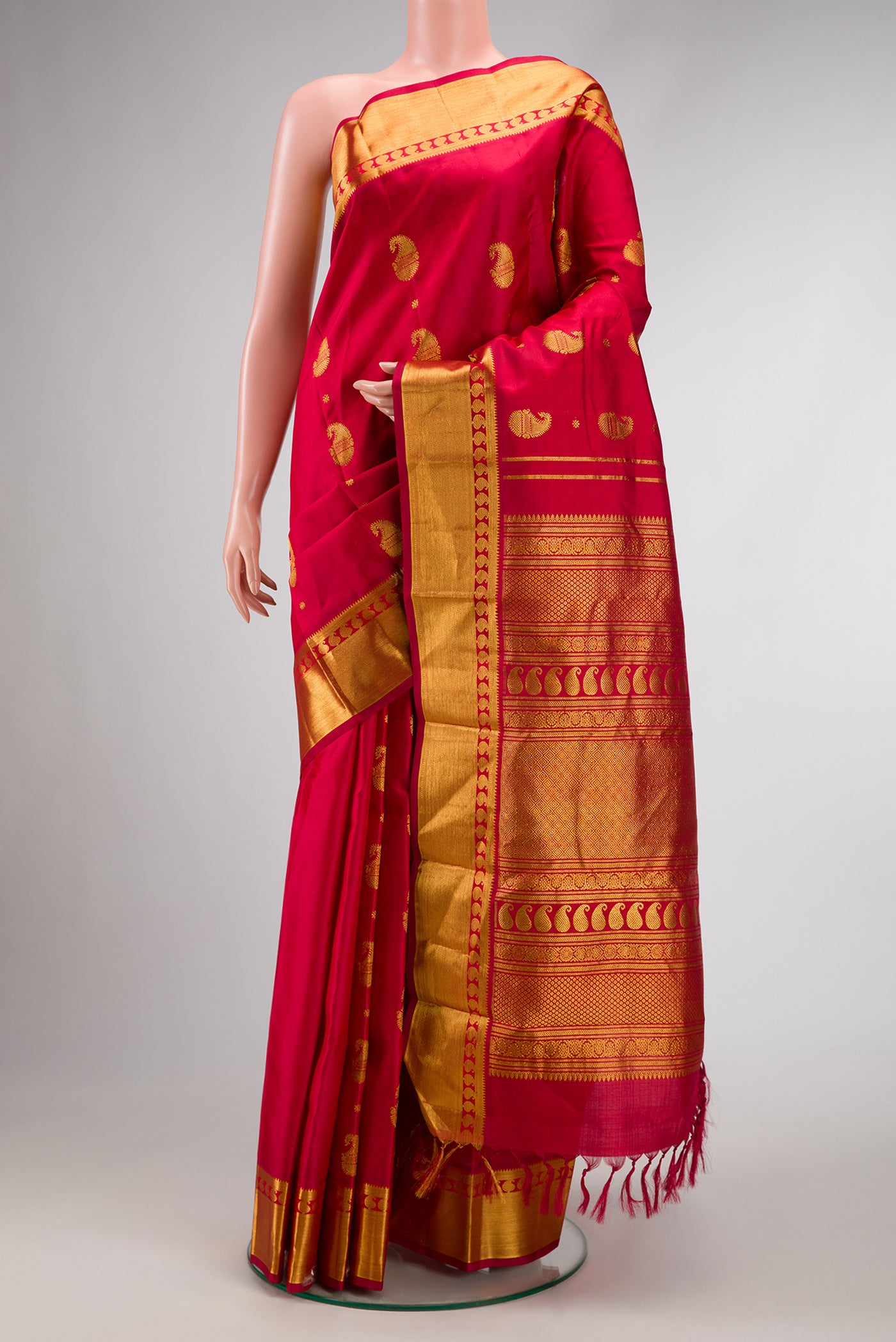 Pure Silk Pure Zari Red Dual Tone Kanjivaram Saree with Zari Butta on the body and Zari Border.  displayed on a mannequin